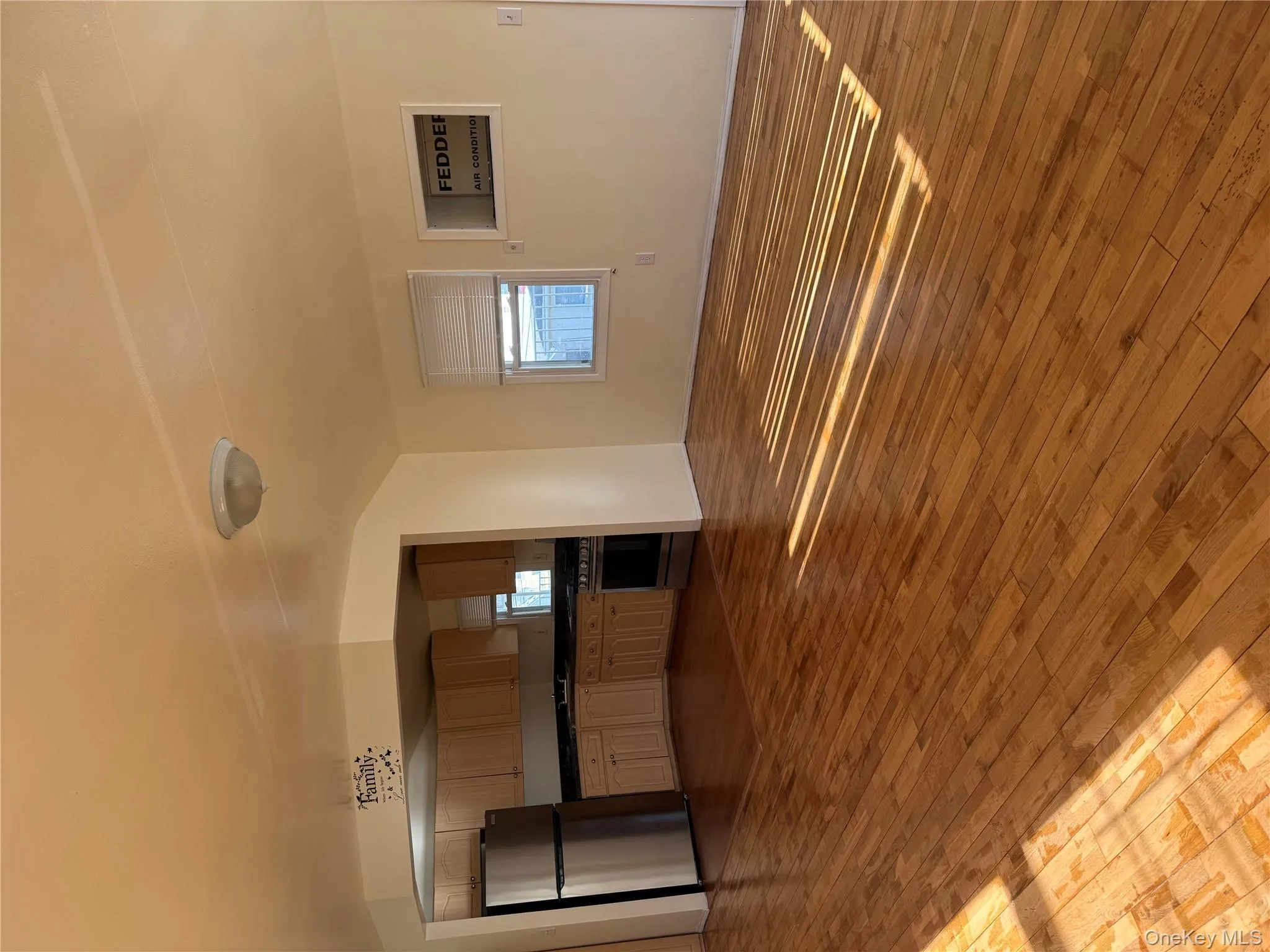 Unfurnished living room featuring dark wood-style flooring Unfurnished living room featuring dark wood-style flooring