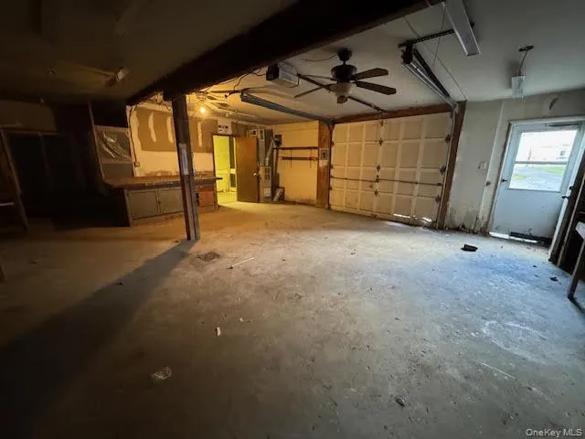 Garage featuring heating unit and a garage door opener Garage featuring heating unit and a garage door opener