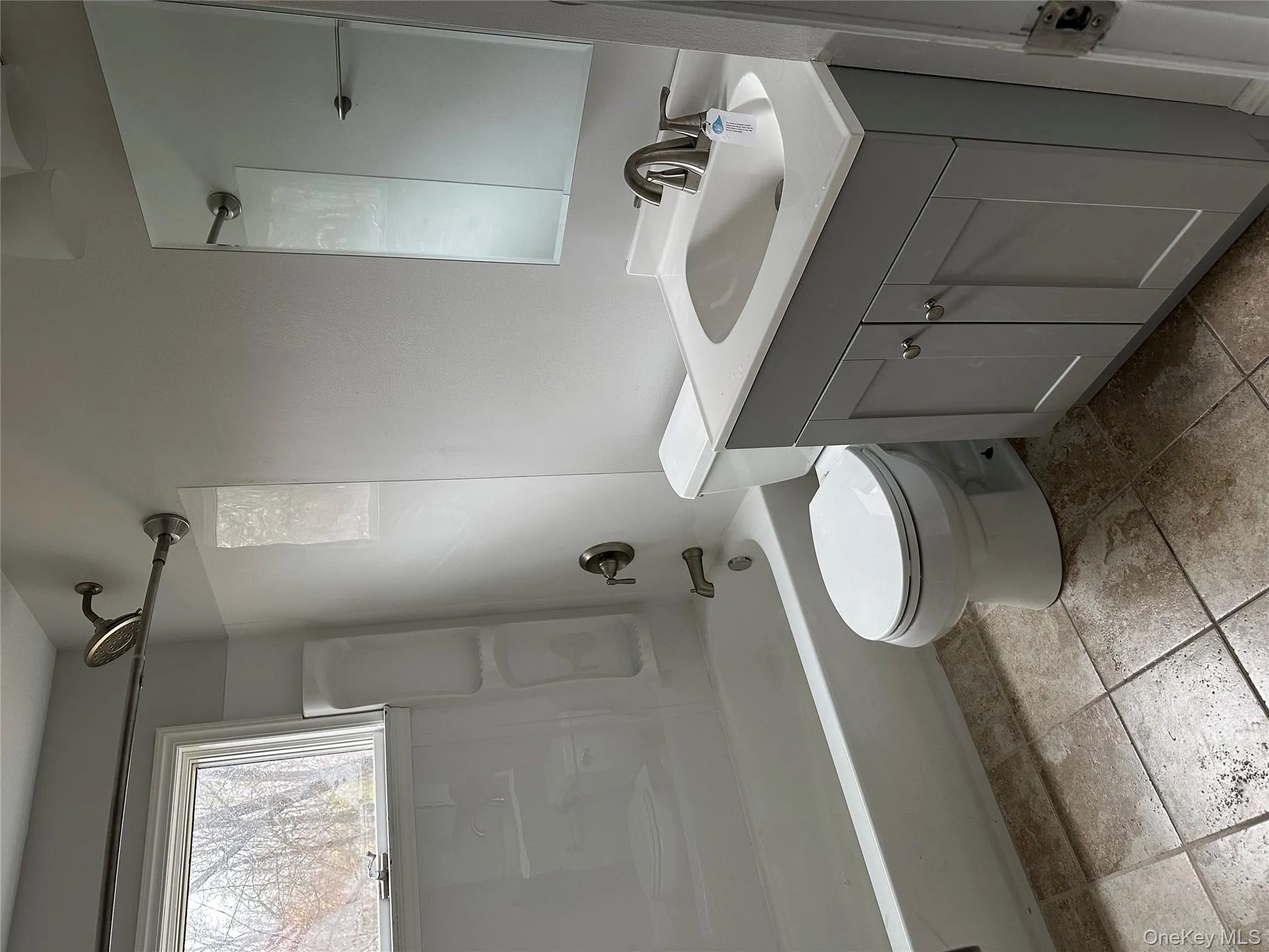 Bathroom featuring vanity and shower / tub combination Bathroom featuring vanity and shower / tub combination