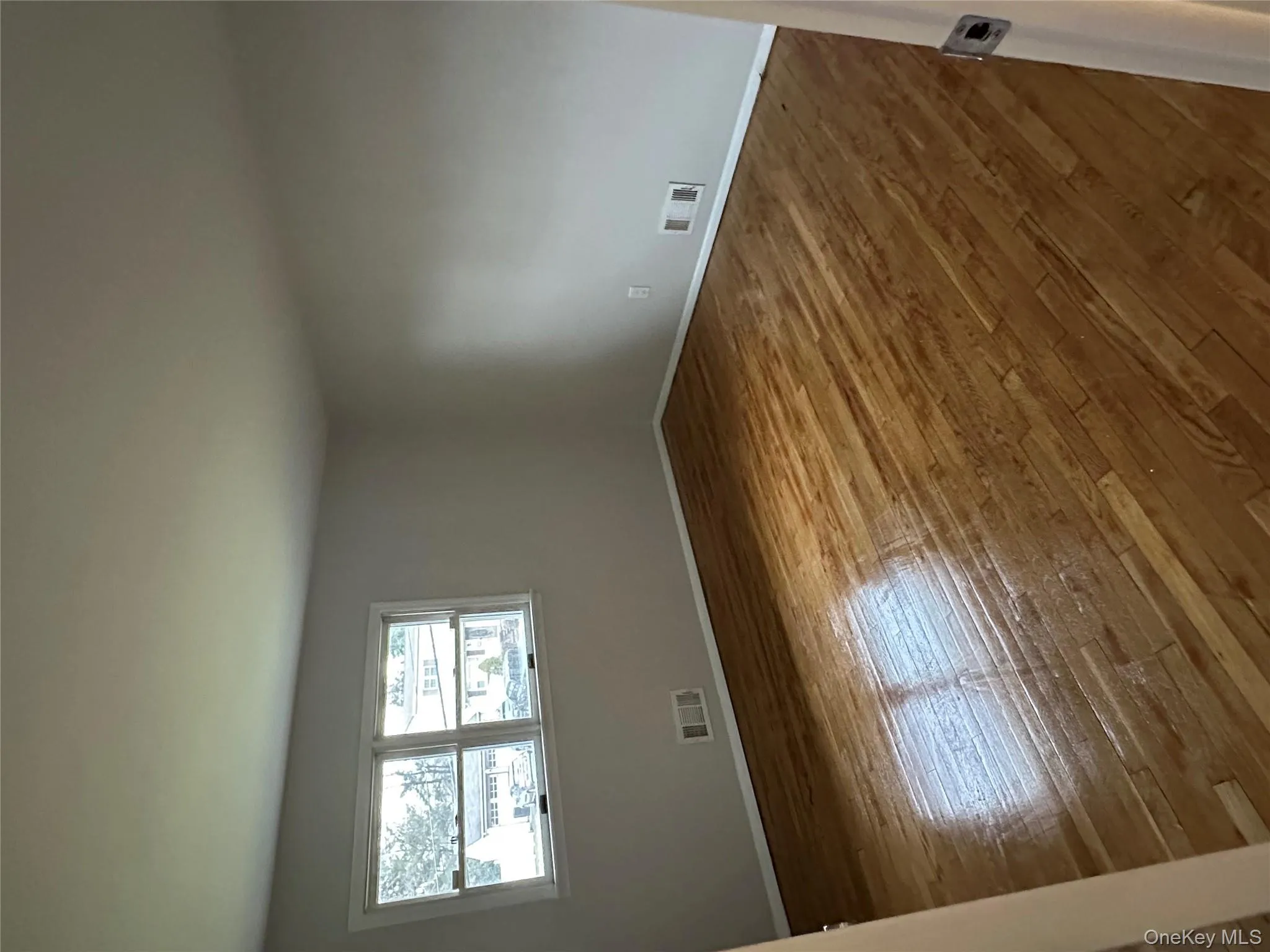 Spare room with hardwood / wood-style flooring and baseboards Spare room with hardwood / wood-style flooring and baseboards