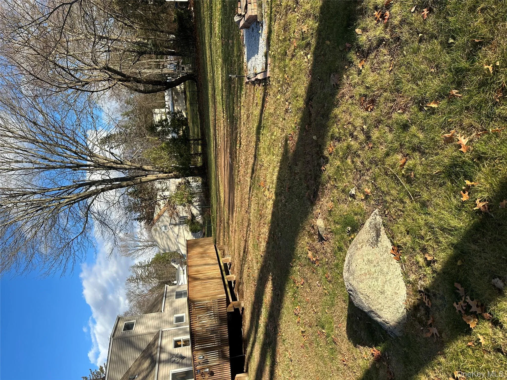 View of green lawn with a deck View of green lawn with a deck