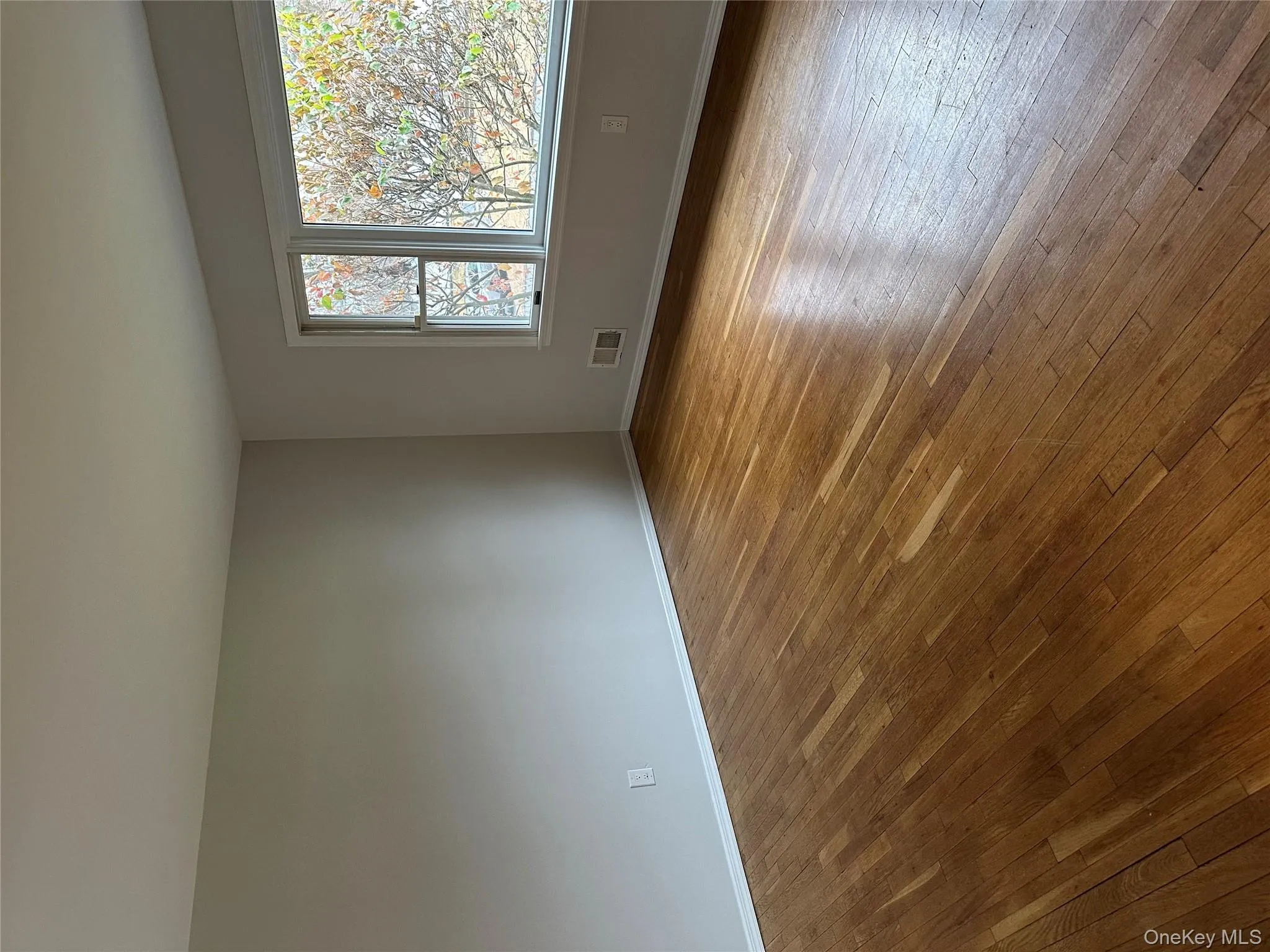 Unfurnished room featuring baseboards and light wood finished floors Unfurnished room featuring baseboards and light wood finished floors