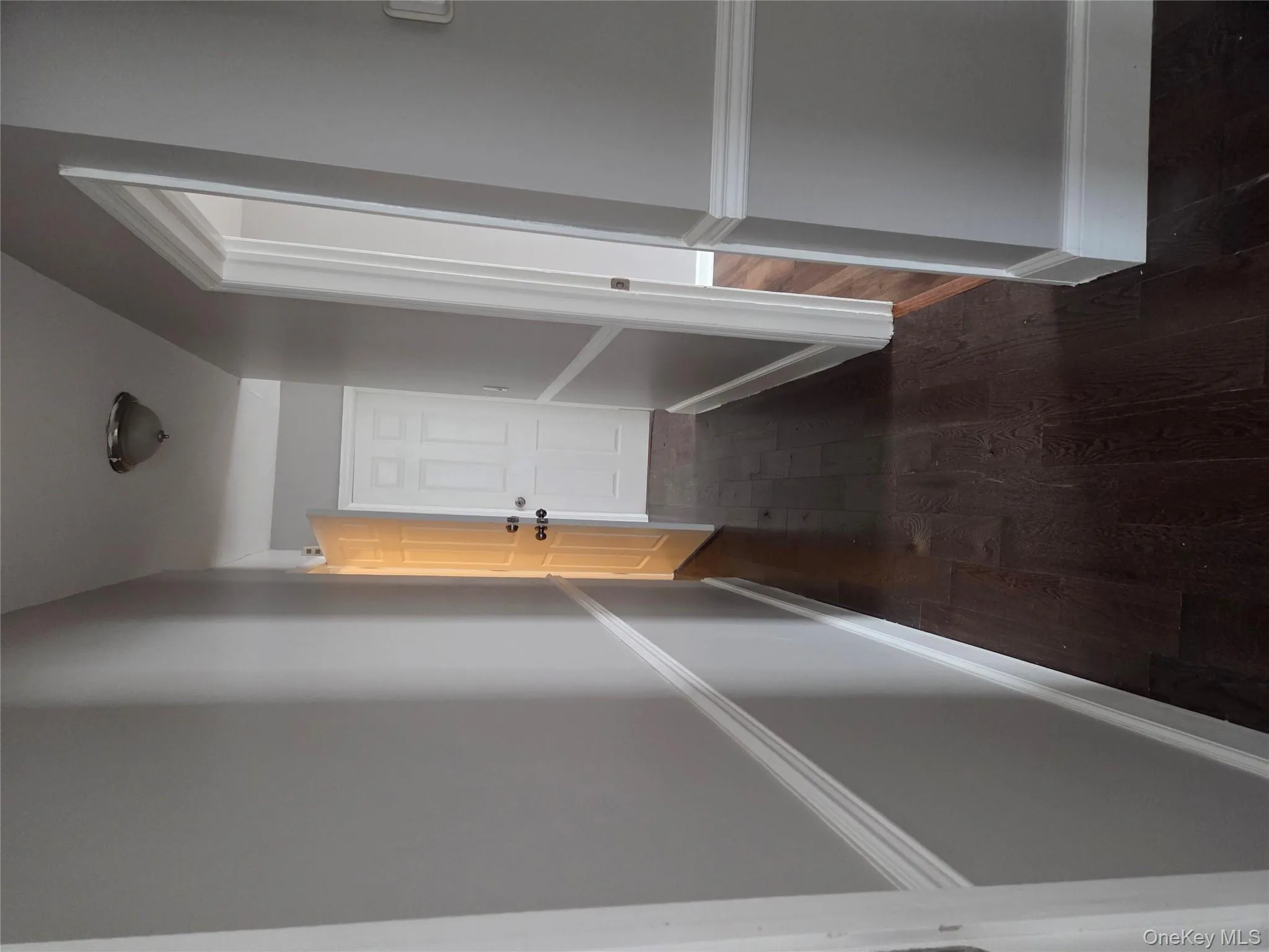 Hall featuring dark wood-style floors Hall featuring dark wood-style floors