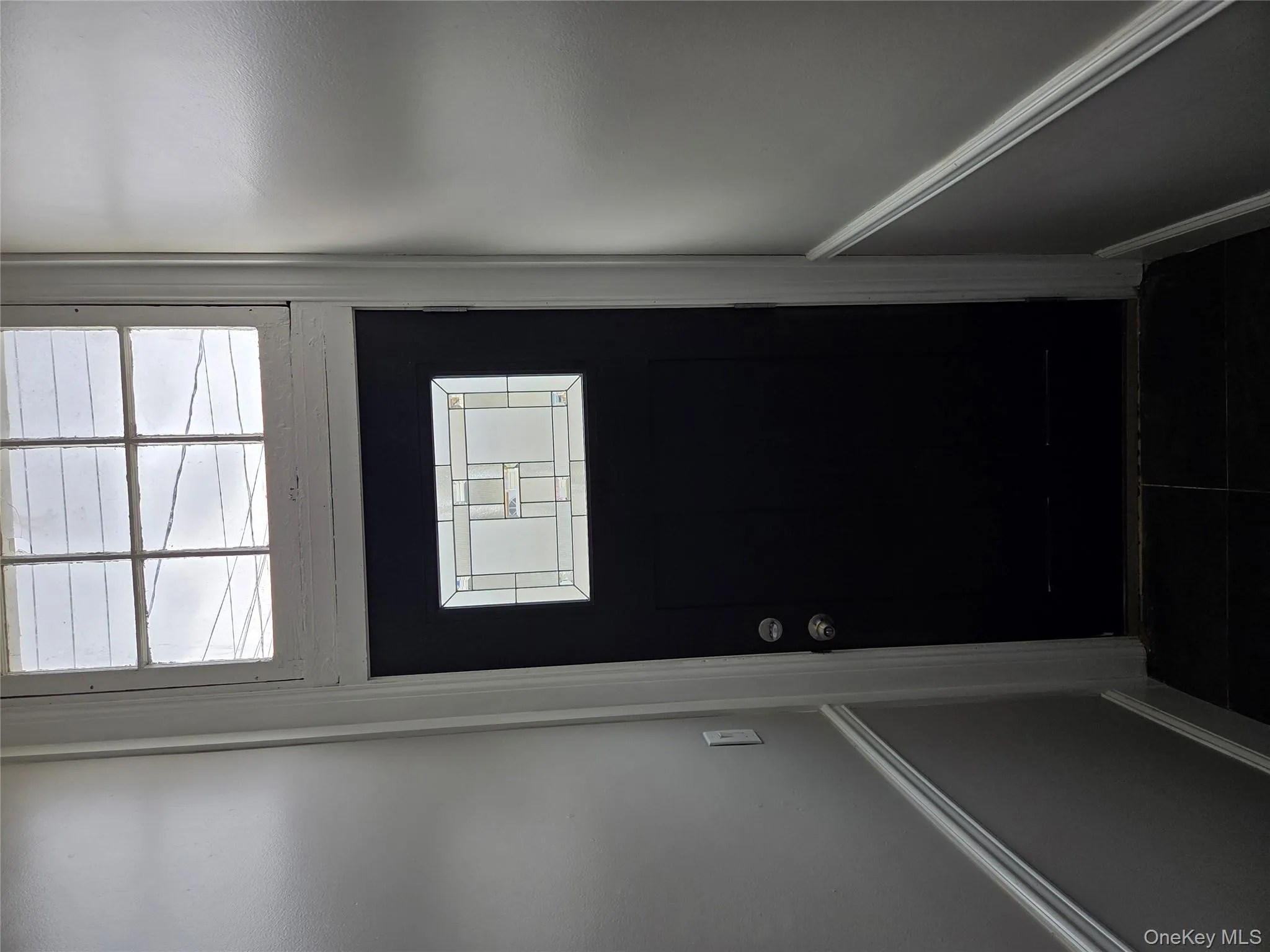 Doorway to outside featuring healthy amount of natural light and tile patterned floors Doorway to outside featuring healthy amount of natural light and tile patterned floors