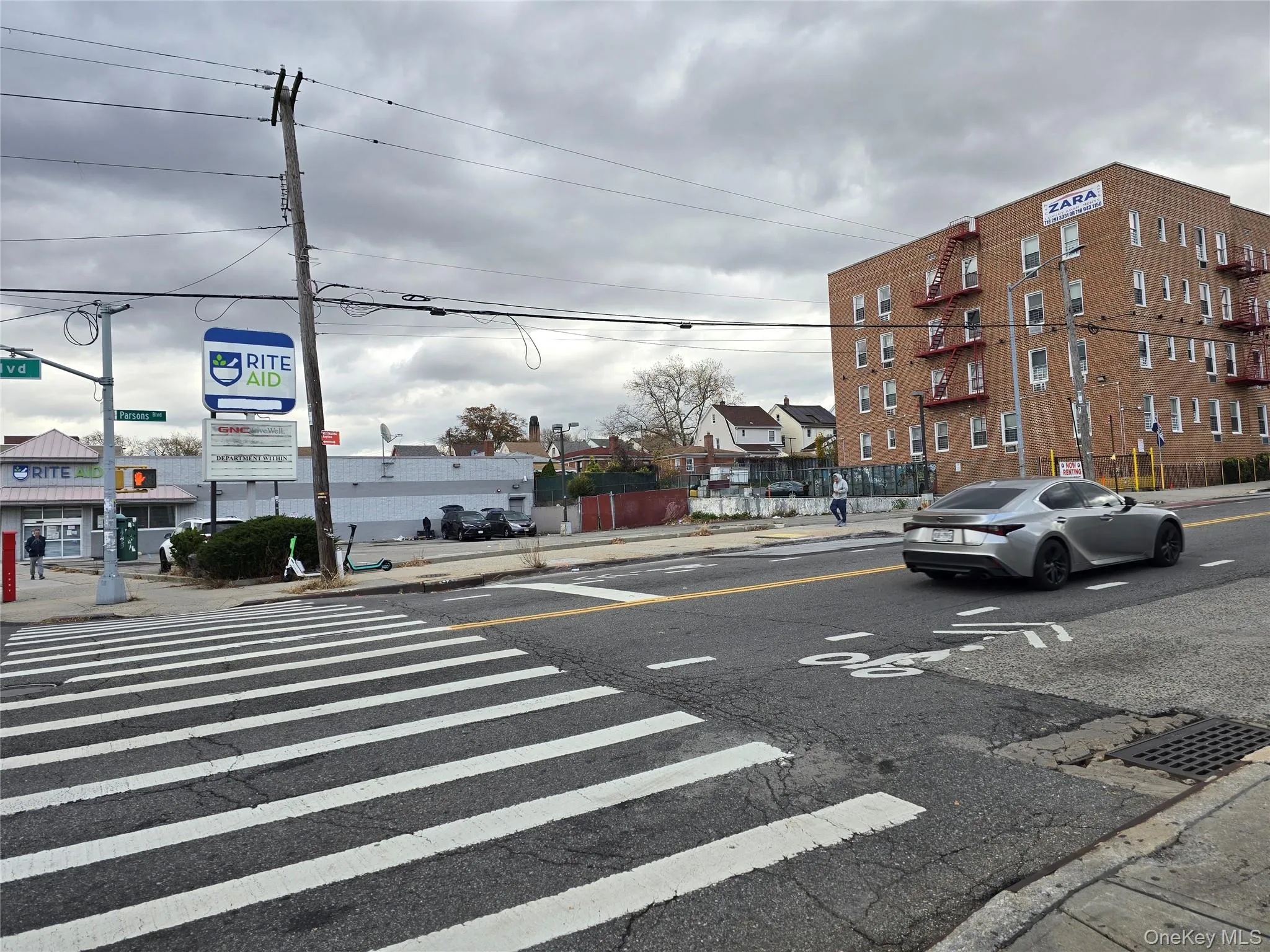 View of asphalt road with sidewalks, curbs, and street lighting View of asphalt road with sidewalks, curbs, and street lighting
