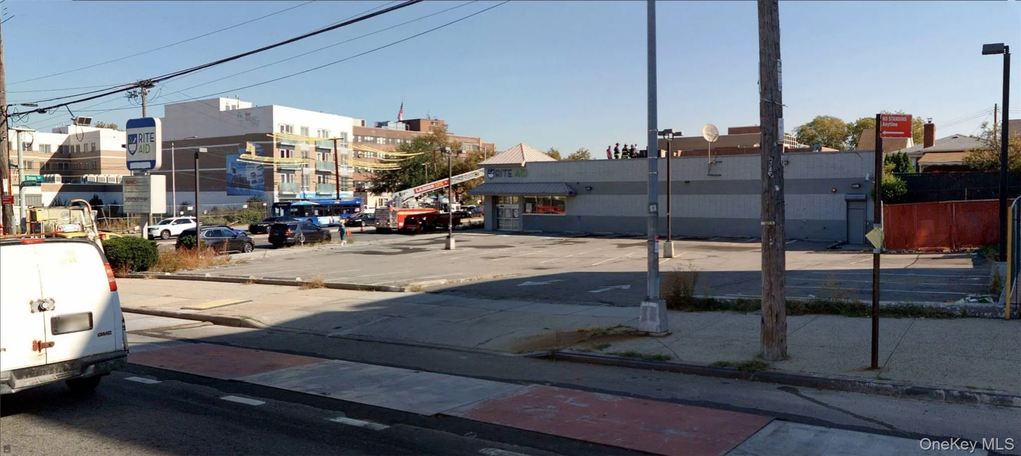 View of asphalt street with curbs and sidewalks View of asphalt street with curbs and sidewalks