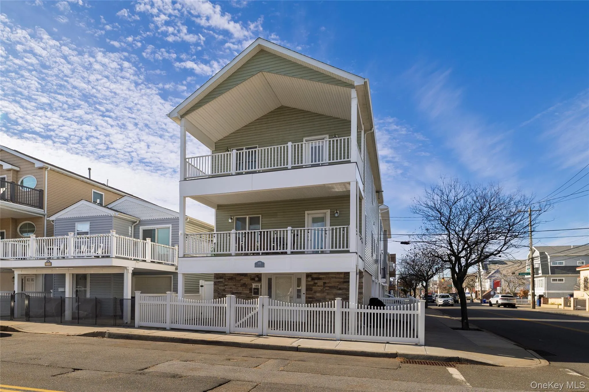 View of front facade with stone siding and a residential view View of front facade with stone siding and a residential view