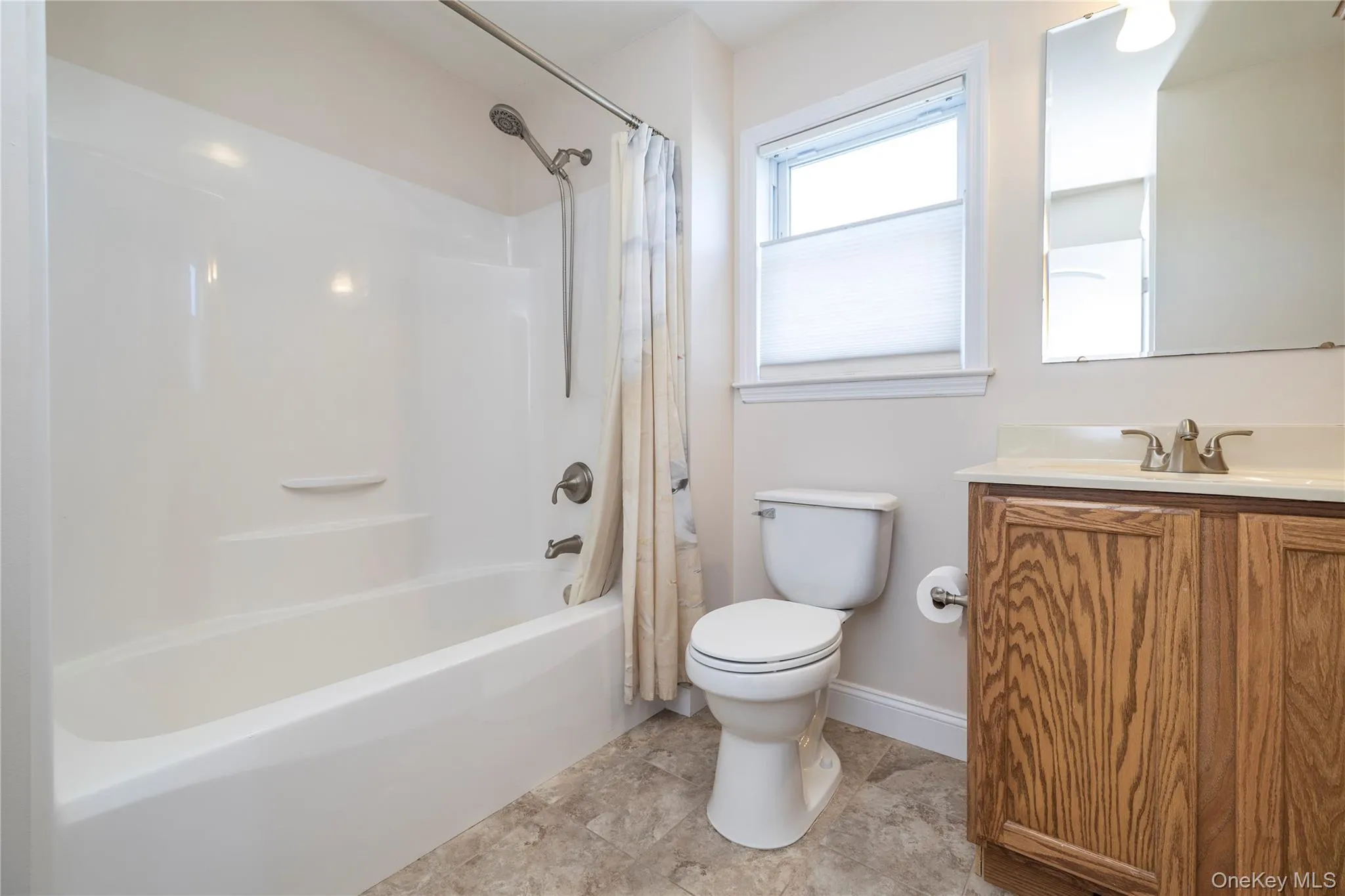 Full bathroom with shower / bathtub combination with curtain and vanity Full bathroom with shower / bathtub combination with curtain and vanity