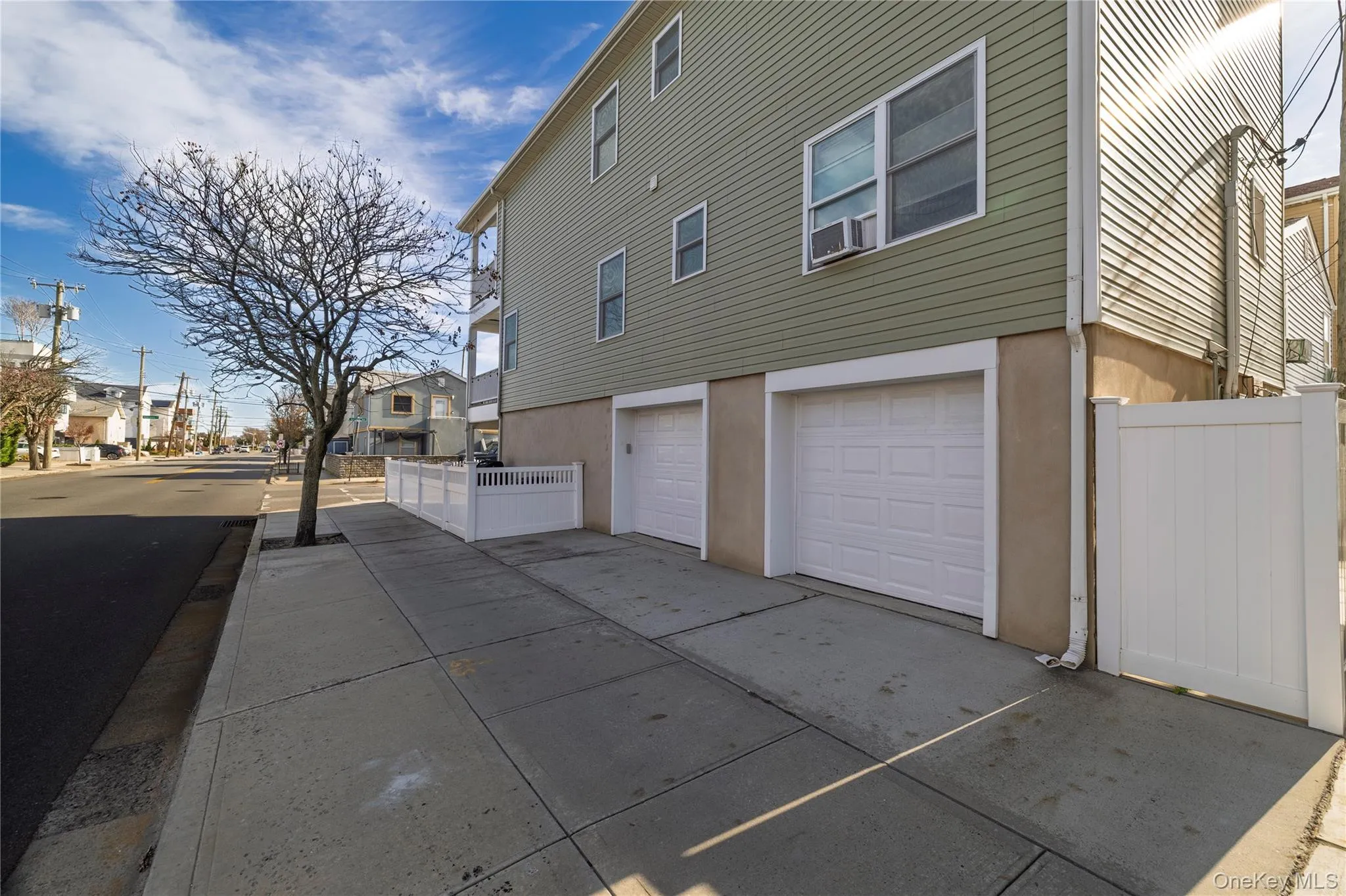 View of property exterior with a residential view, an attached garage, stucco siding, and driveway View of property exterior with a residential view, an attached garage, stucco siding, and driveway