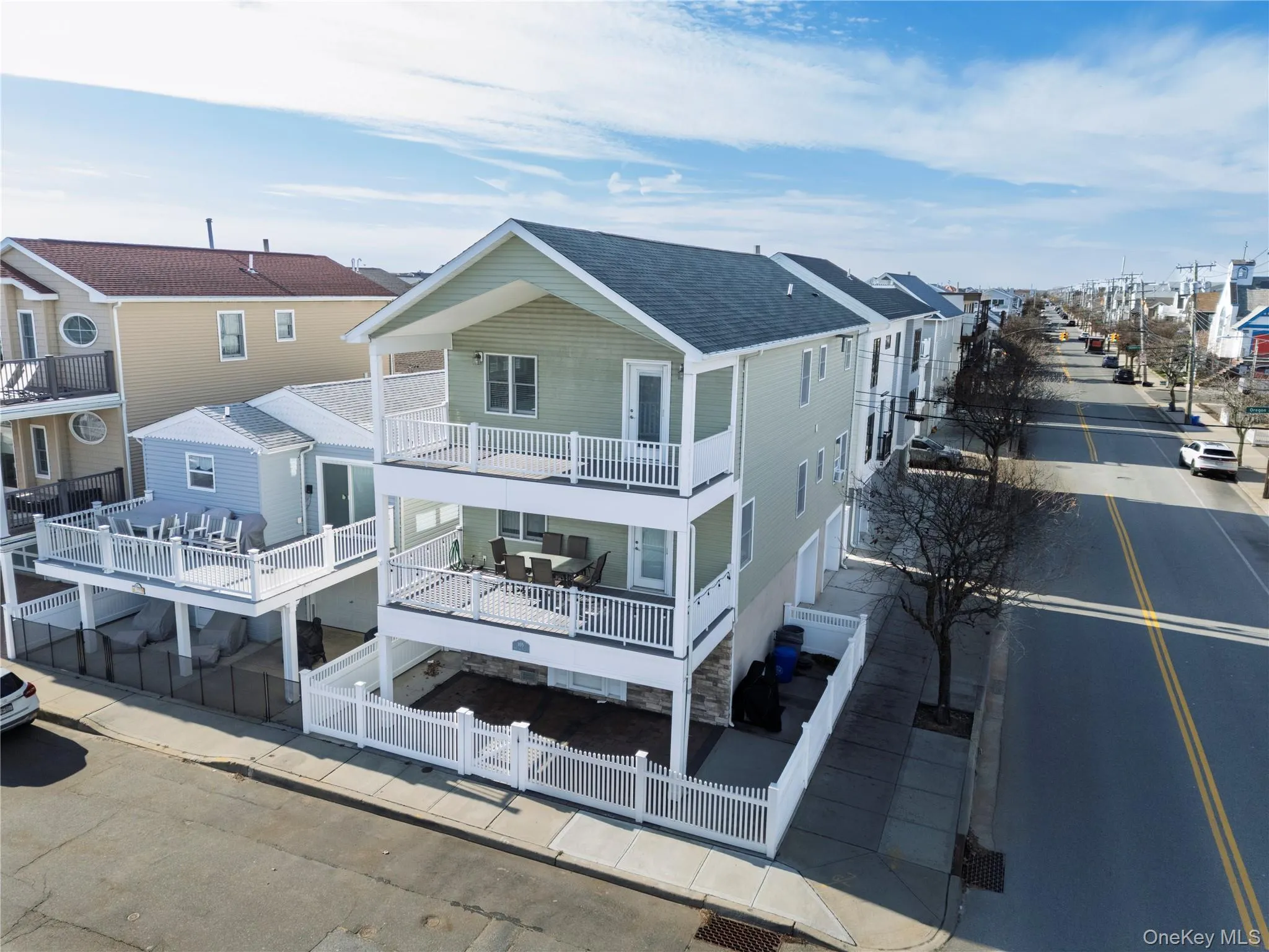 Rear view of house featuring a fenced front yard, a residential view, and roof with shingles Rear view of house featuring a fenced front yard, a residential view, and roof with shingles