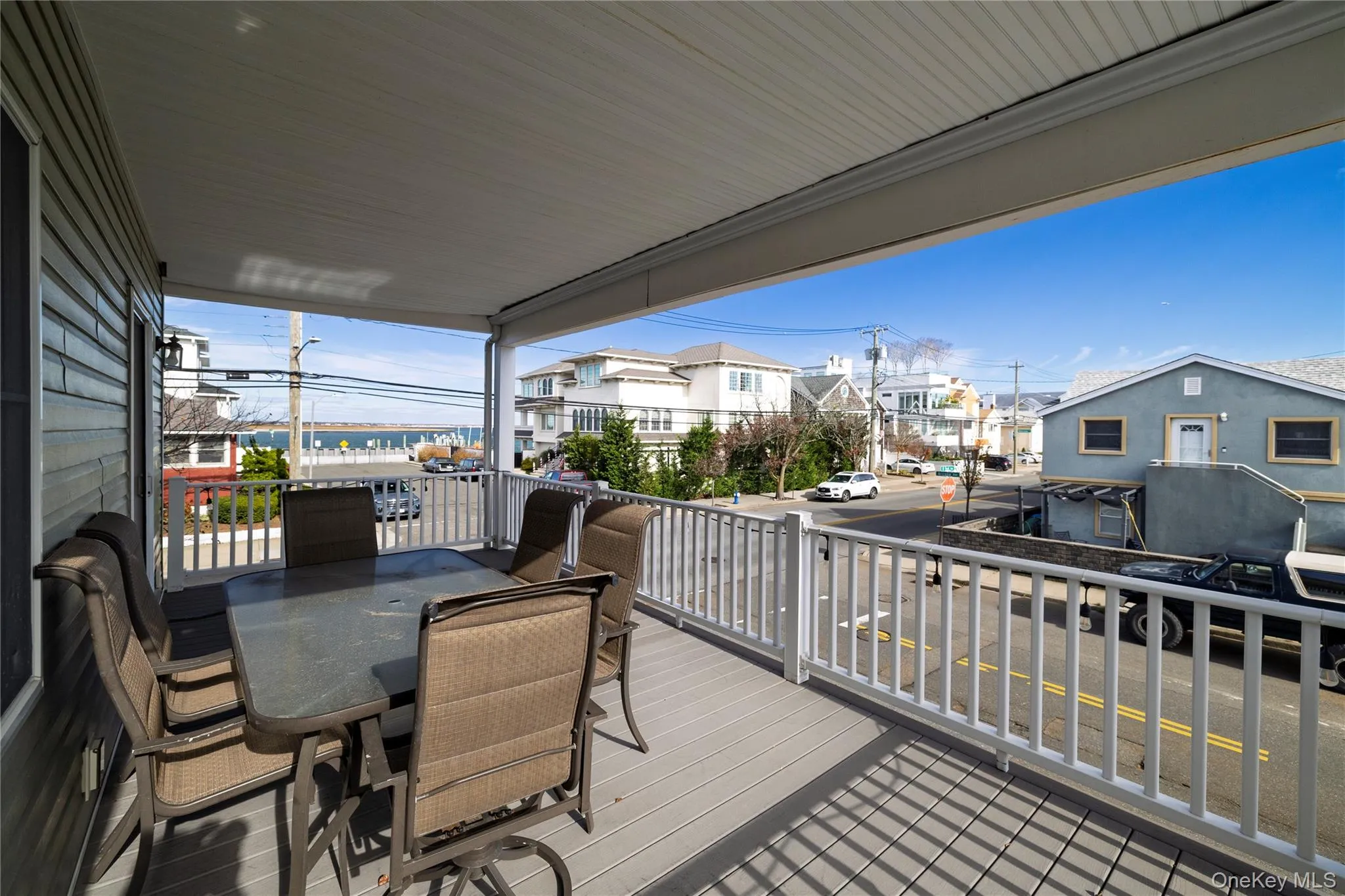 Wooden deck featuring a residential view and outdoor dining area Wooden deck featuring a residential view and outdoor dining area