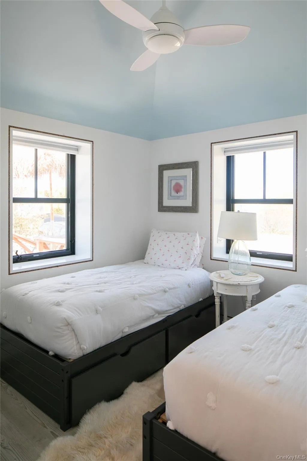 Bedroom featuring a ceiling fan and vaulted ceiling Bedroom featuring a ceiling fan and vaulted ceiling