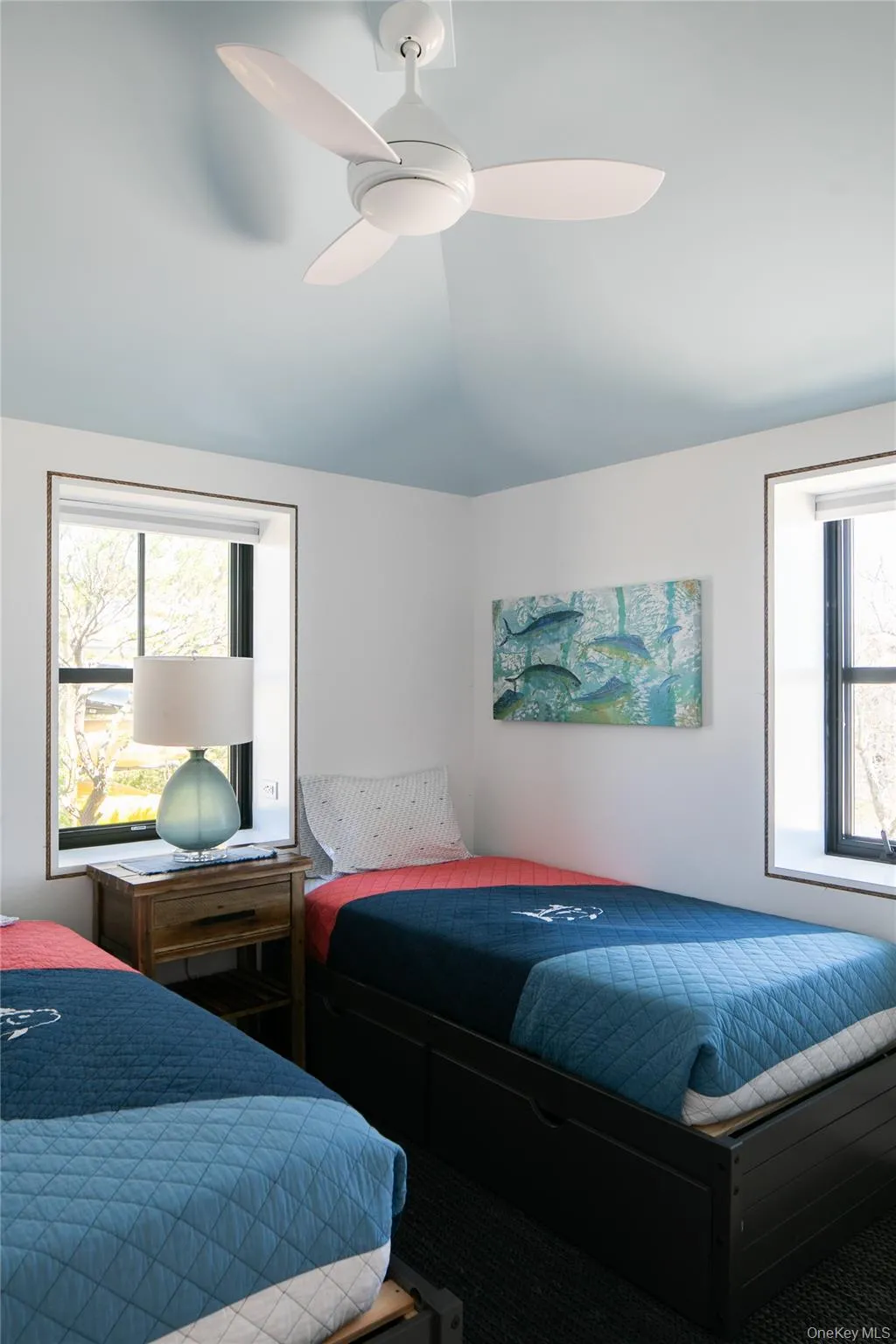 Bedroom featuring multiple windows and a ceiling fan Bedroom featuring multiple windows and a ceiling fan