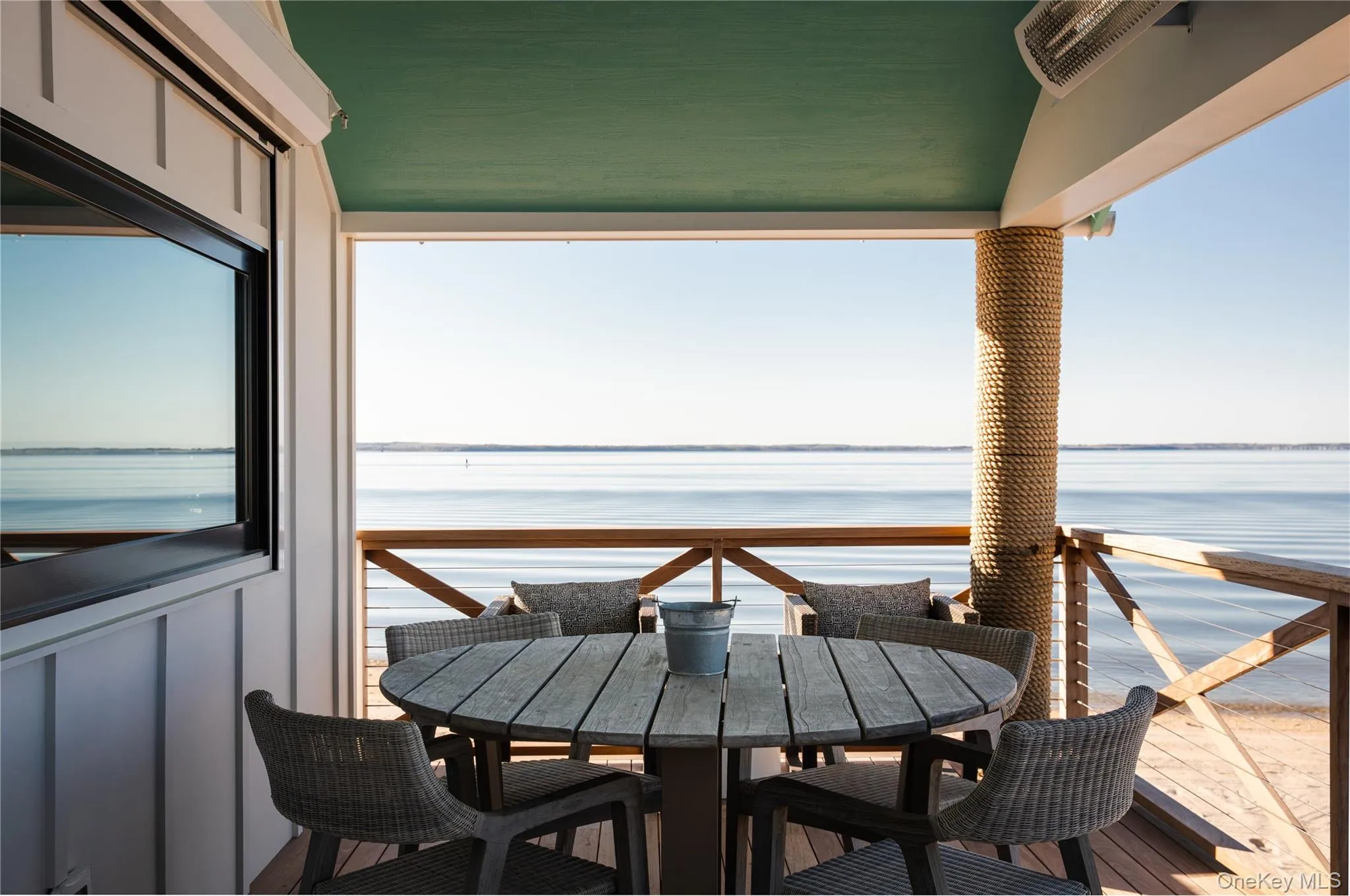 Balcony featuring outdoor dining area and a water view Balcony featuring outdoor dining area and a water view