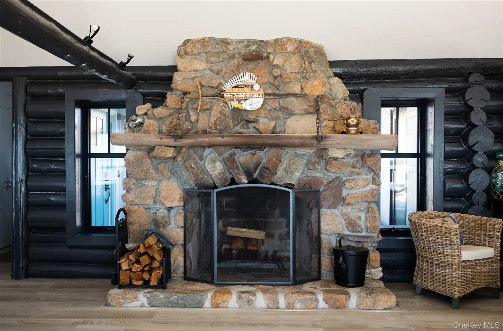Detailed view of a fireplace, wood finished floors, and rustic walls Detailed view of a fireplace, wood finished floors, and rustic walls