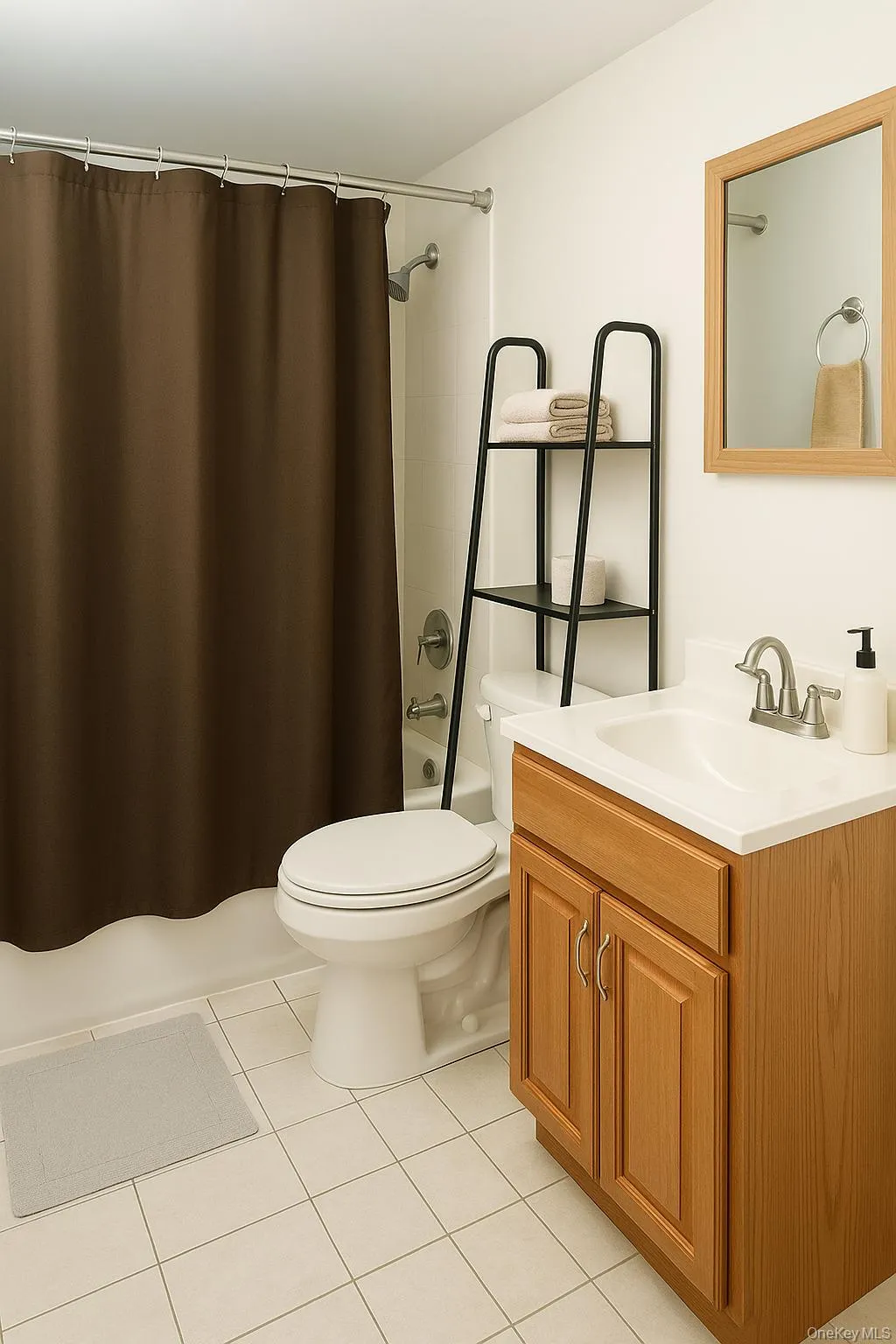 Full bathroom with vanity, light tile patterned floors, and shower / bath combo with shower curtain Full bathroom with vanity, light tile patterned floors, and shower / bath combo with shower curtain