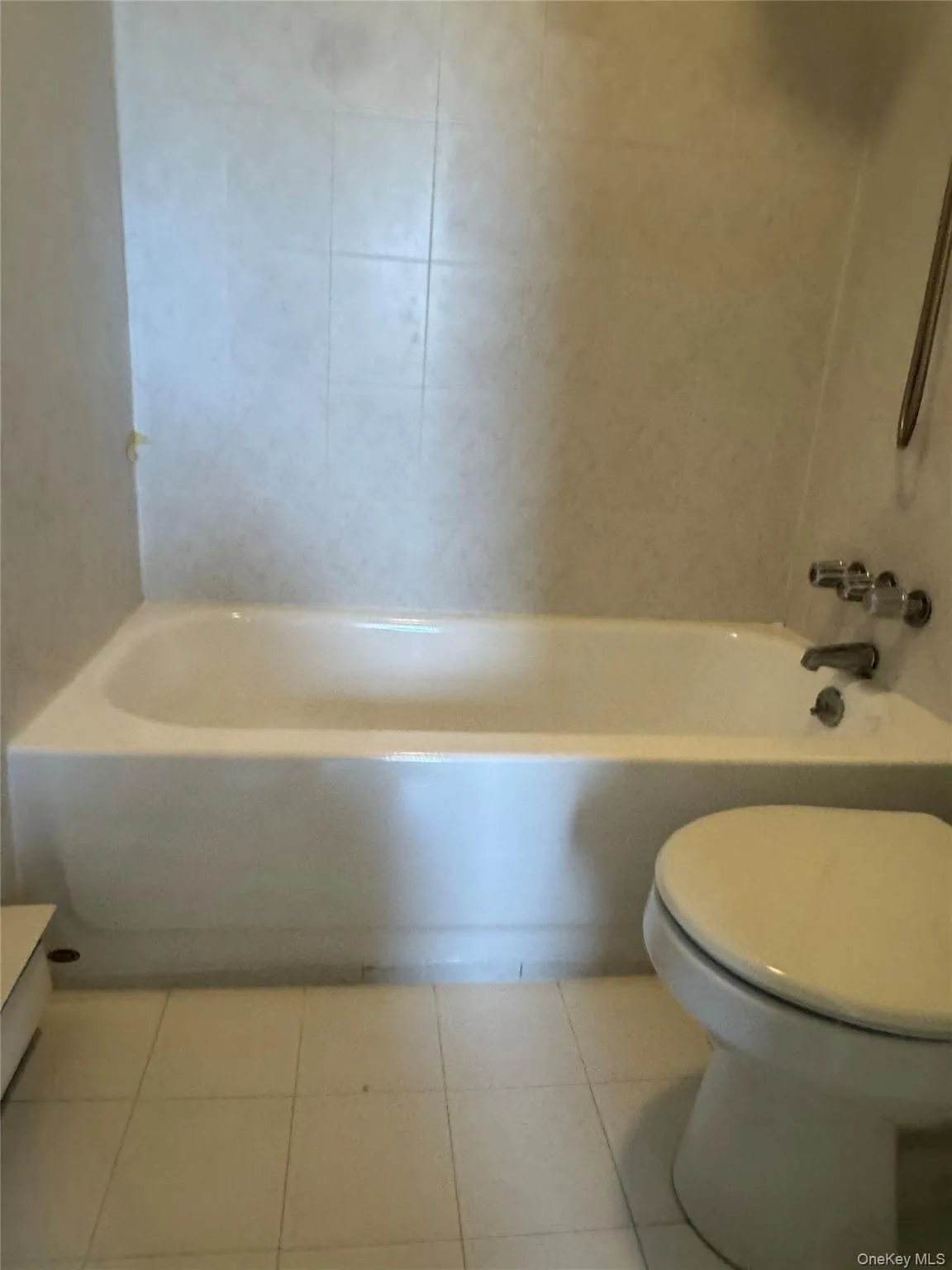 Full bath with light tile patterned floors and washtub / shower combination Full bath with light tile patterned floors and washtub / shower combination