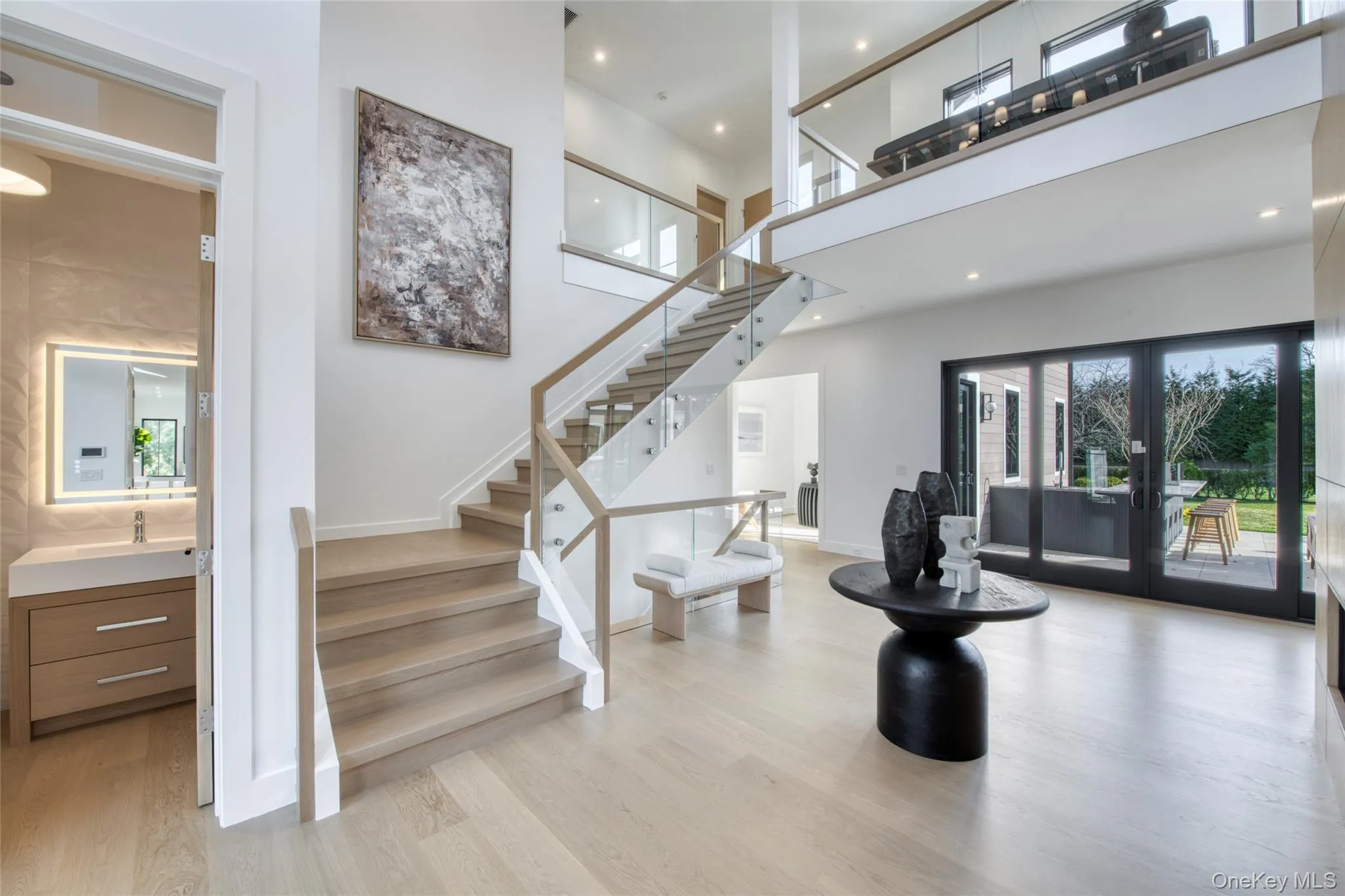 Stairs with french doors, wood finished floors, and a high ceiling Stairs with french doors, wood finished floors, and a high ceiling