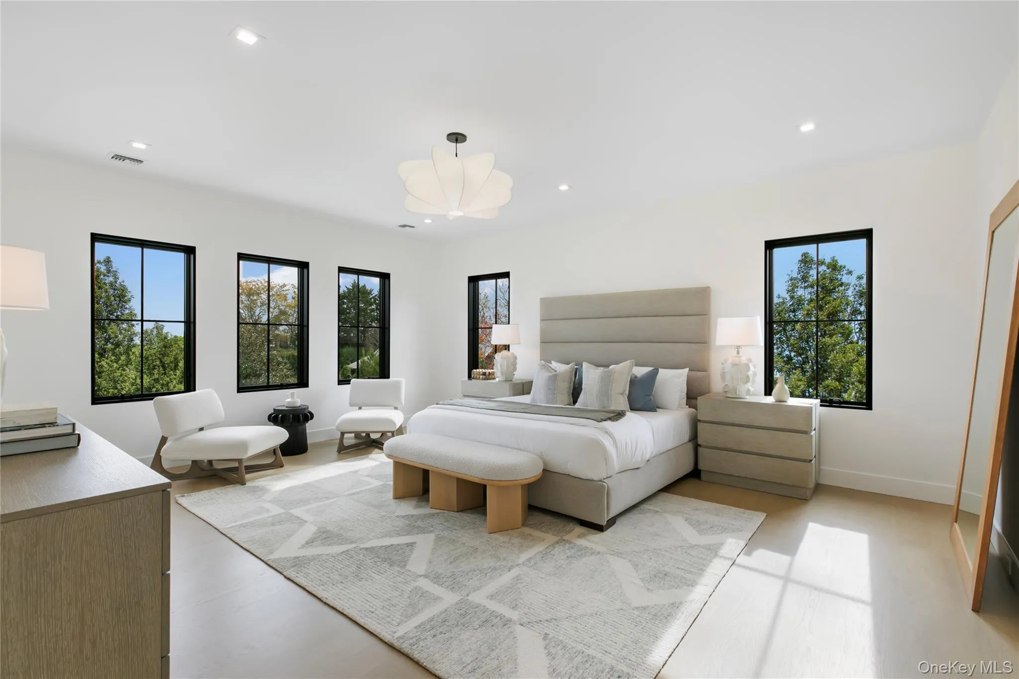 Bedroom featuring multiple windows, recessed lighting, and light wood finished floors Bedroom featuring multiple windows, recessed lighting, and light wood finished floors