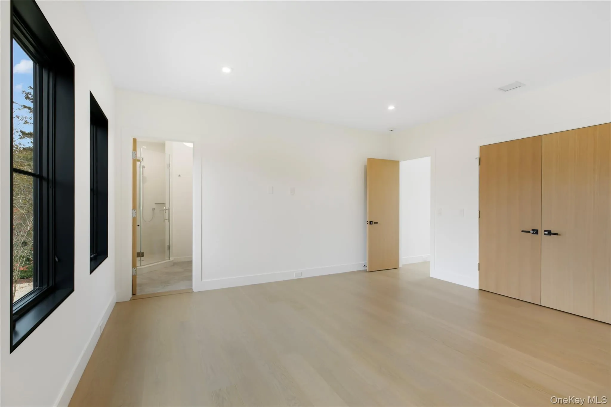 Unfurnished bedroom featuring light wood-type flooring, recessed lighting, and connected bathroom Unfurnished bedroom featuring light wood-type flooring, recessed lighting, and connected bathroom