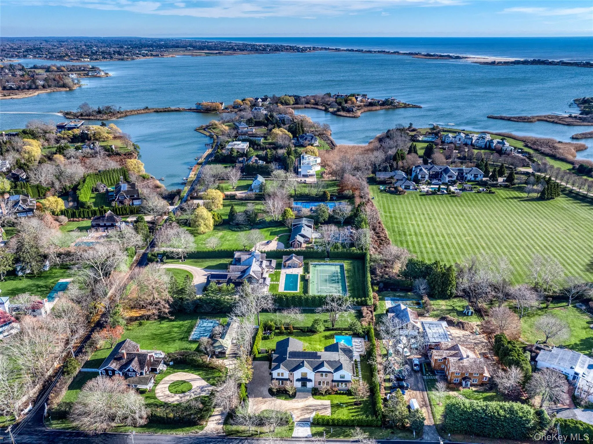 Aerial view of property's location with a large body of water and nearby suburban area Aerial view of property's location with a large body of water and nearby suburban area