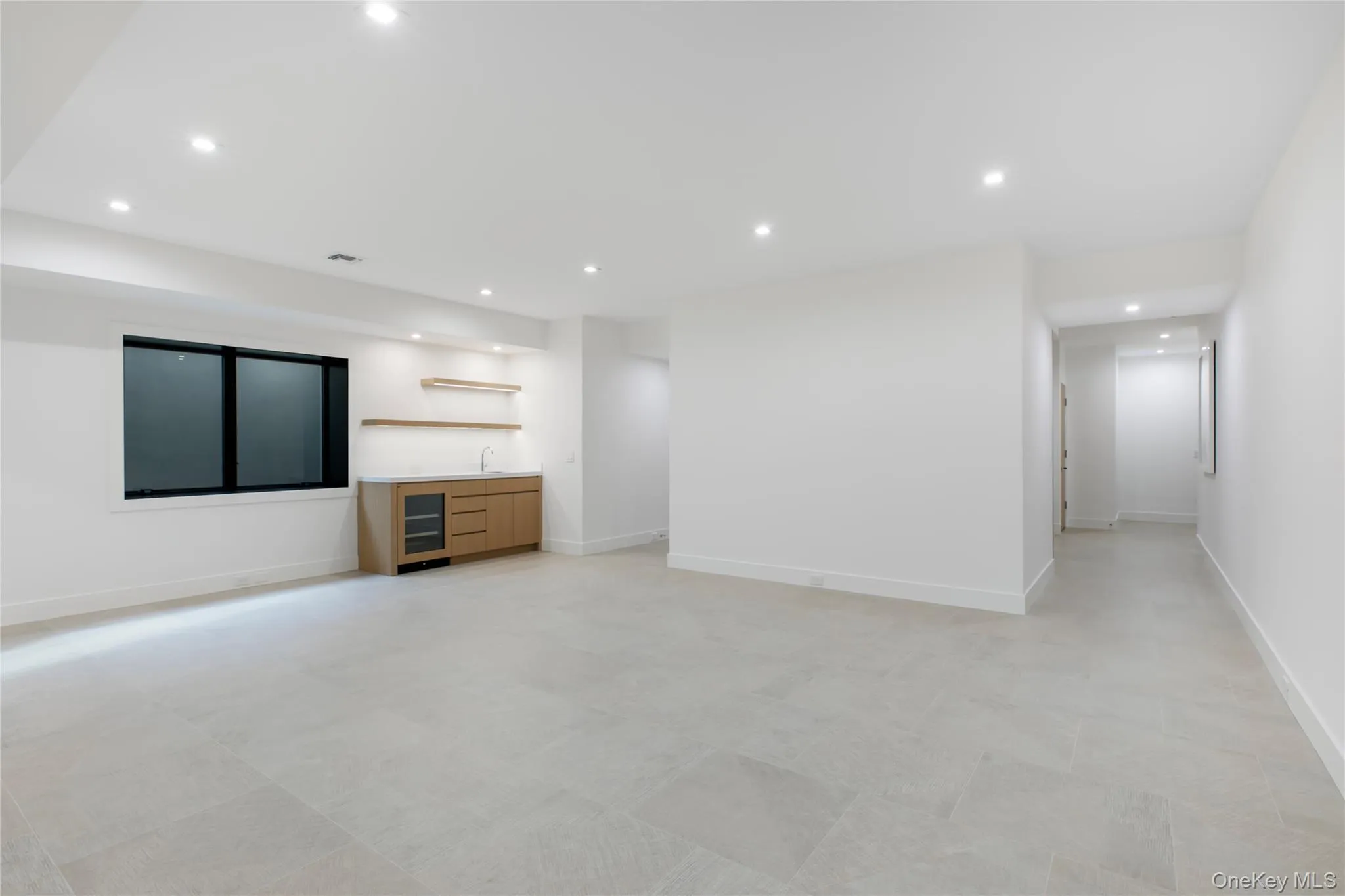 Unfurnished living room featuring recessed lighting, wet bar, and beverage cooler Unfurnished living room featuring recessed lighting, wet bar, and beverage cooler