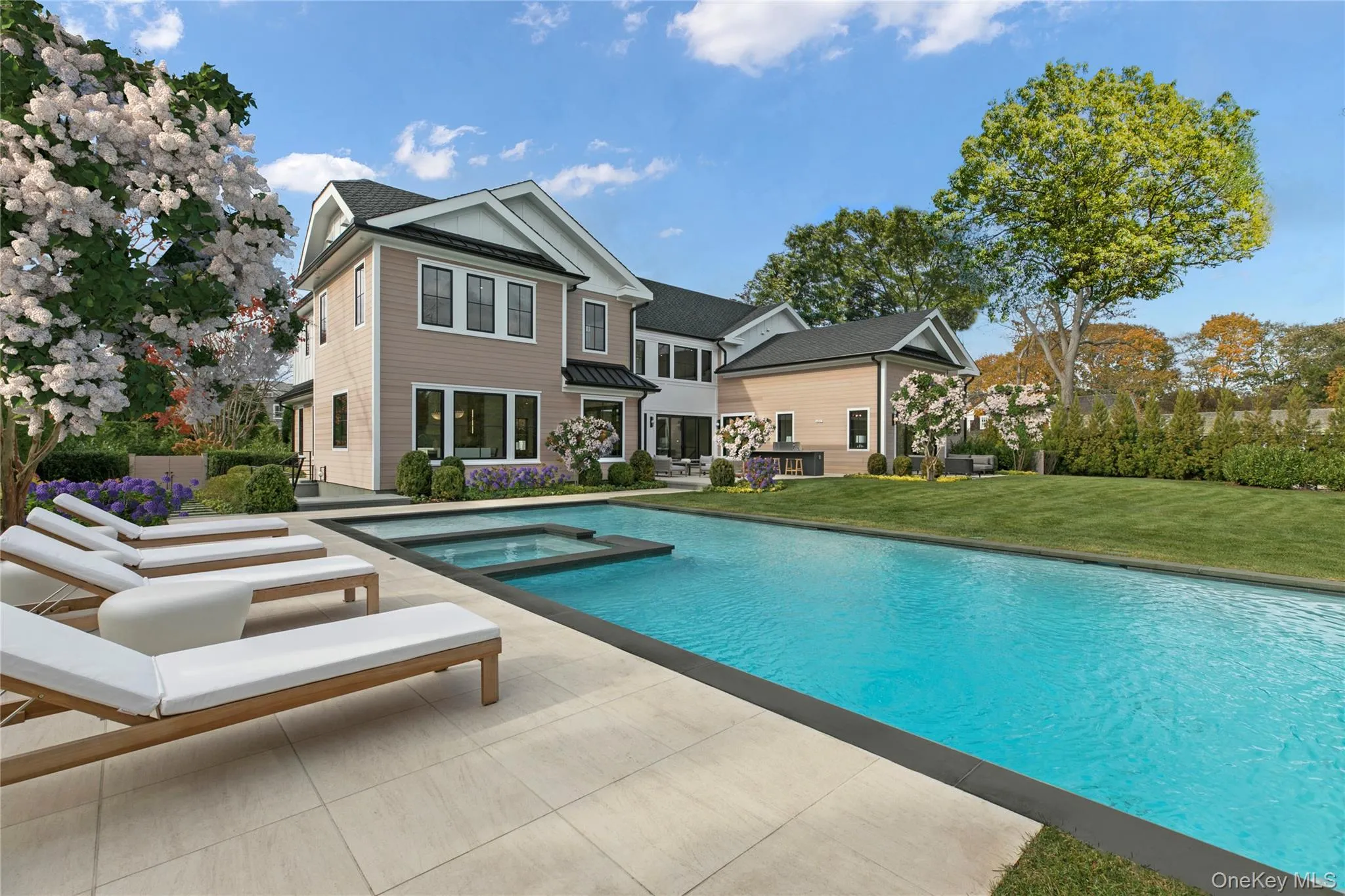 View of swimming pool featuring a lawn, a patio area, and a pool with connected hot tub View of swimming pool featuring a lawn, a patio area, and a pool with connected hot tub