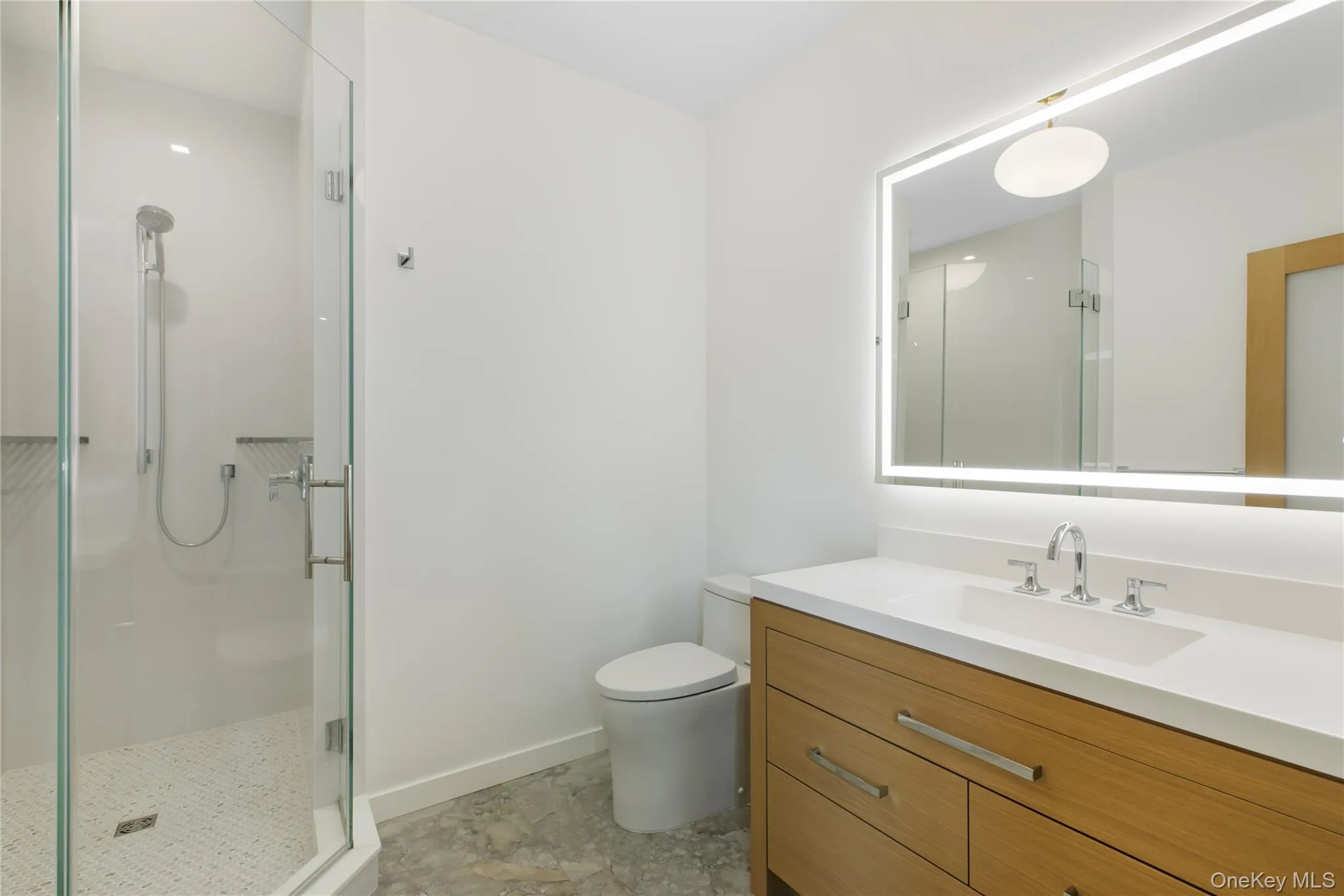 Bathroom featuring a stall shower and vanity Bathroom featuring a stall shower and vanity