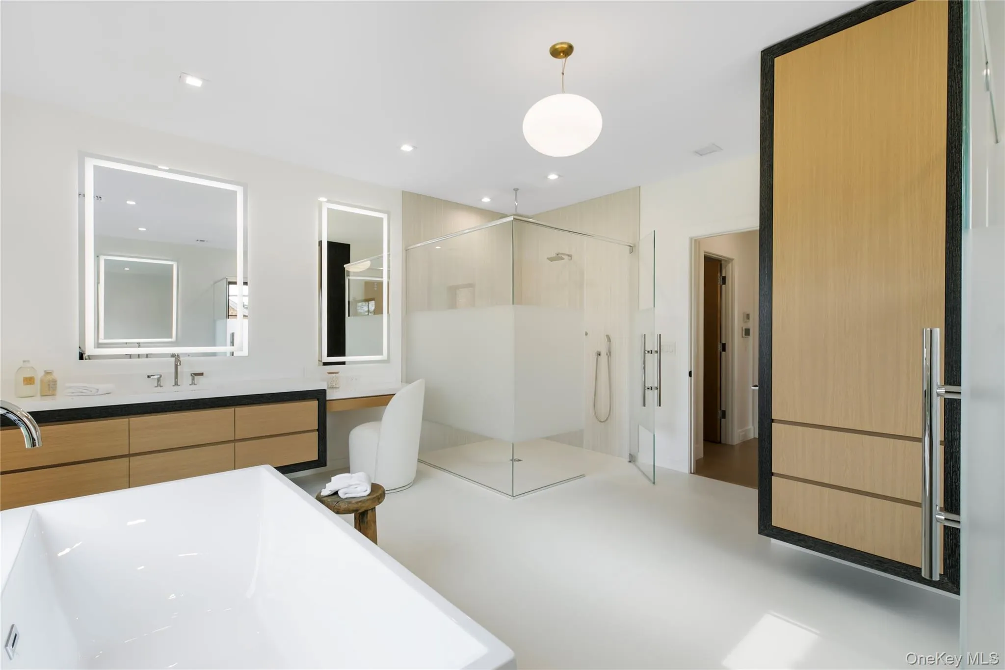 Full bathroom with a soaking tub, vanity, a shower stall, recessed lighting, and concrete floors Full bathroom with a soaking tub, vanity, a shower stall, recessed lighting, and concrete floors