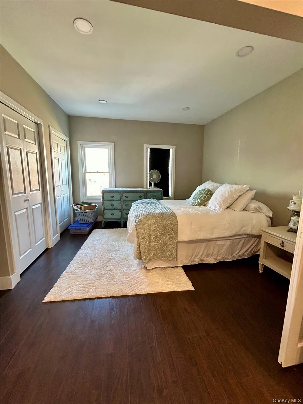 Bedroom featuring two closets, dark wood-type flooring, and recessed lighting Bedroom featuring two closets, dark wood-type flooring, and recessed lighting