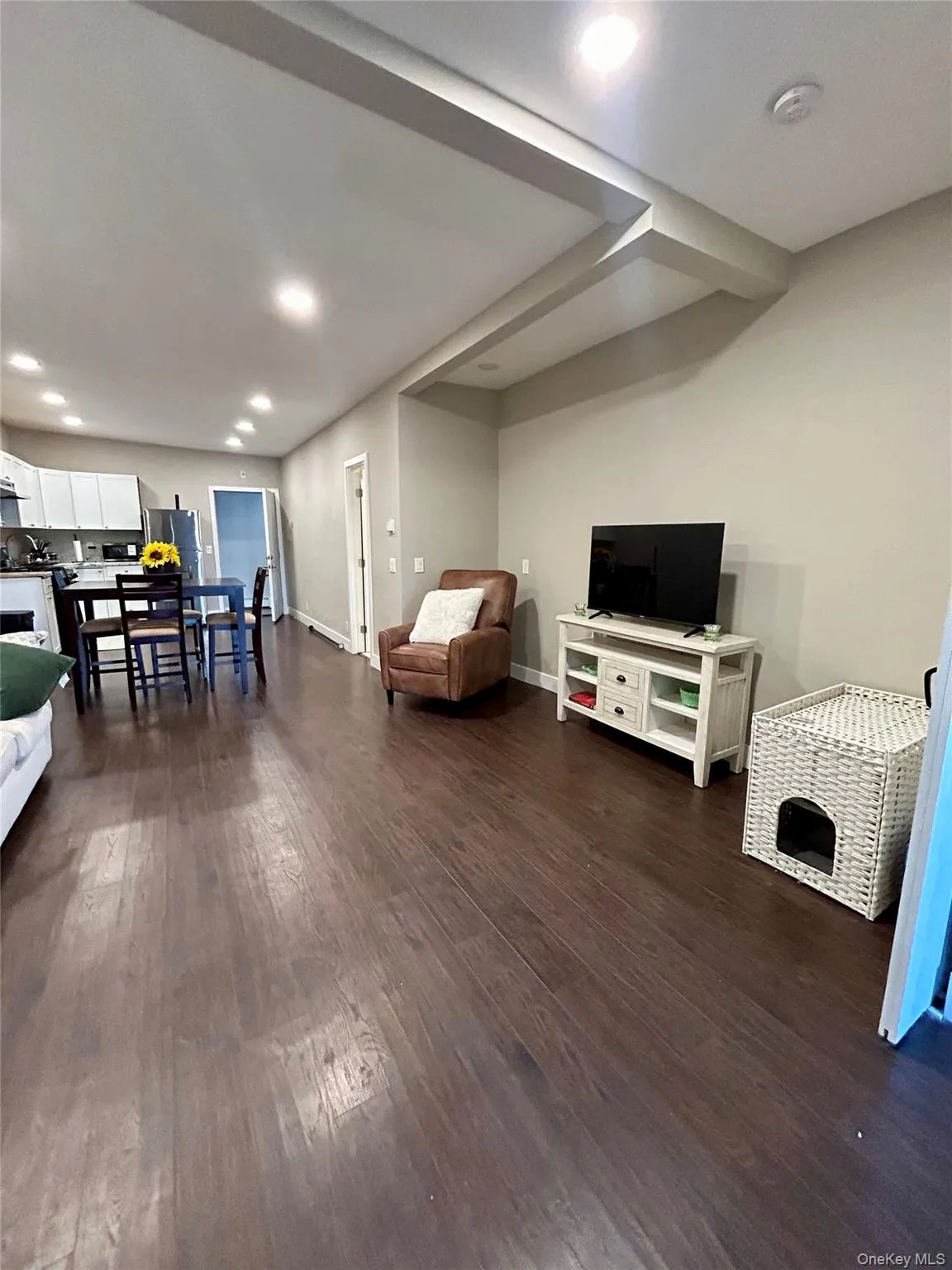 Living area with recessed lighting and dark wood finished floors Living area with recessed lighting and dark wood finished floors