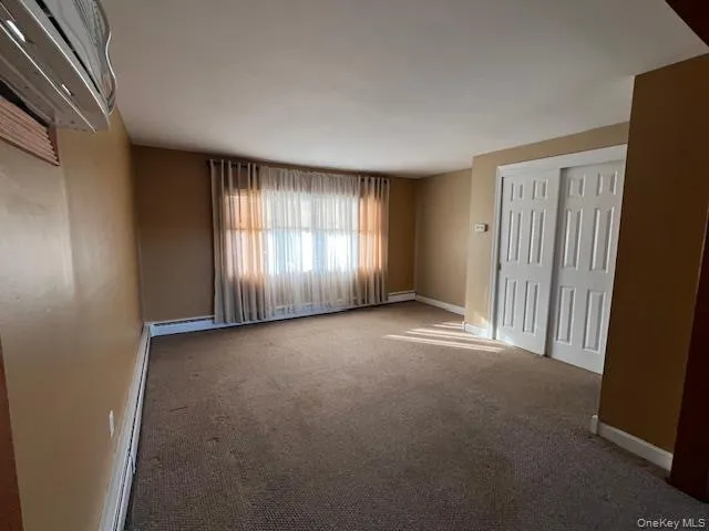 Large LR with carpet floors and baseboard heating Large LR with carpet floors and baseboard heating