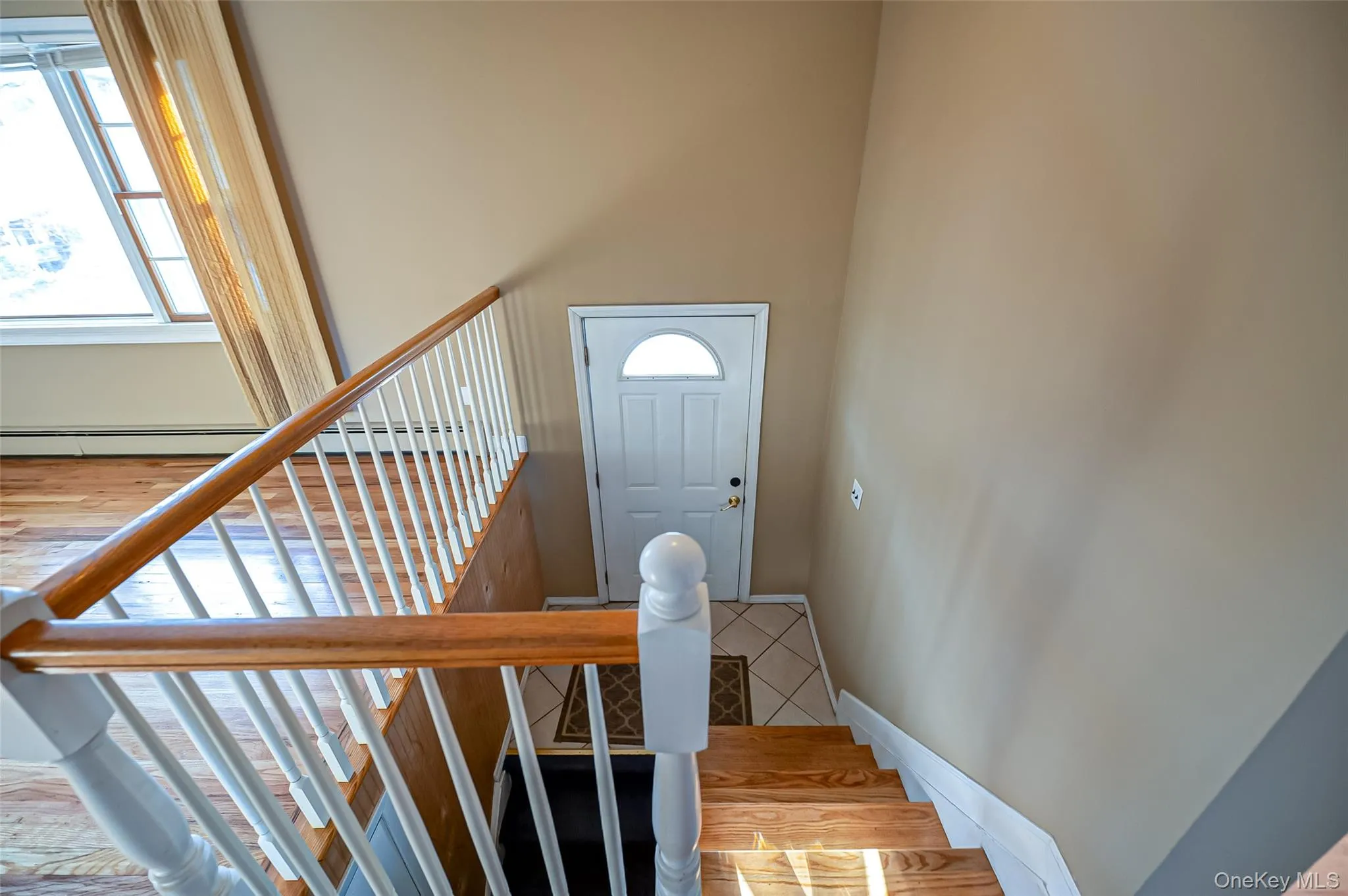 Staircase featuring a baseboard heating unit Staircase featuring a baseboard heating unit