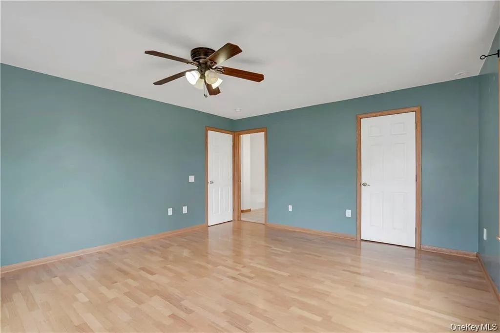 Unfurnished bedroom featuring light wood-style flooring and ceiling fan Unfurnished bedroom featuring light wood-style flooring and ceiling fan
