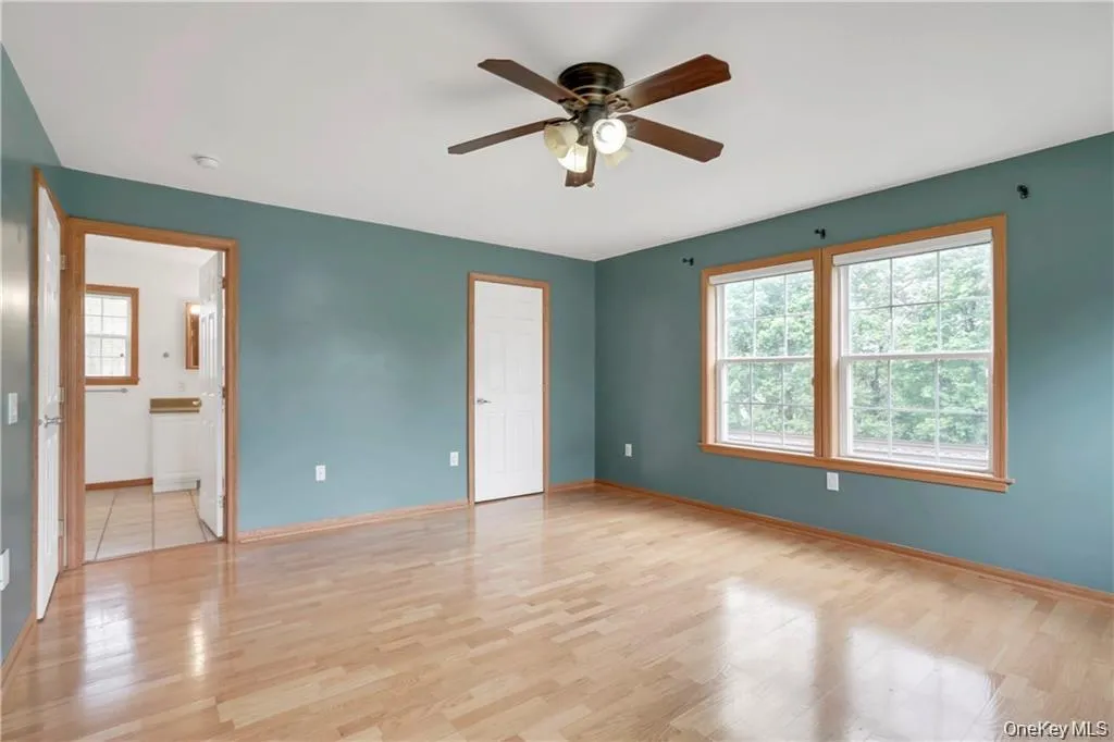 Unfurnished bedroom with light wood finished floors and ceiling fan Unfurnished bedroom with light wood finished floors and ceiling fan
