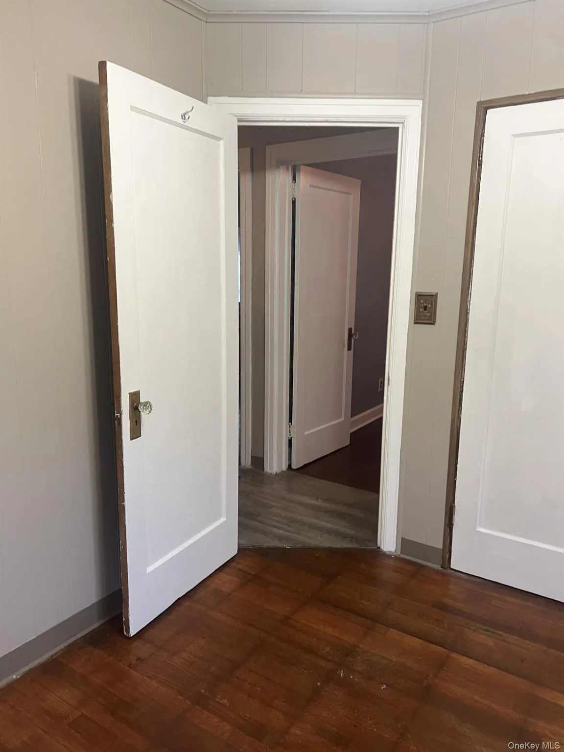 Hallway featuring dark wood-style floors Hallway featuring dark wood-style floors