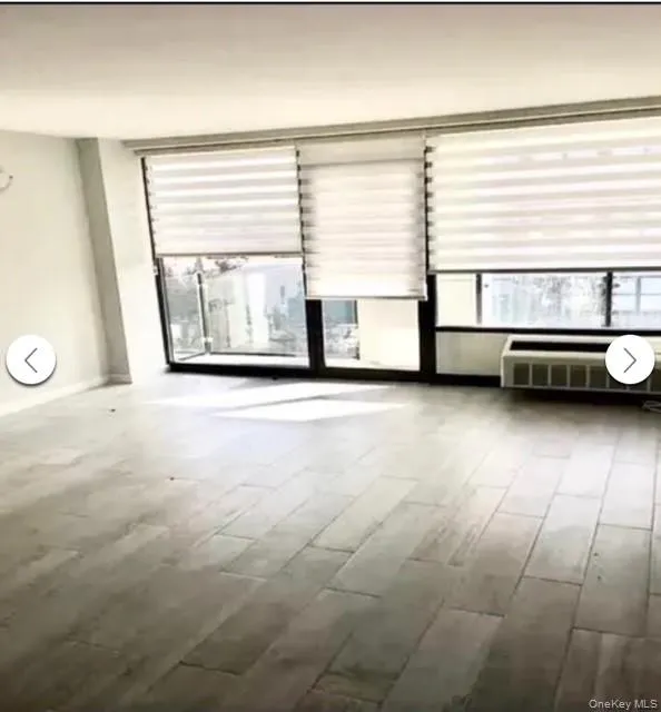 Spare room featuring plenty of natural light and wood finished floors Spare room featuring plenty of natural light and wood finished floors