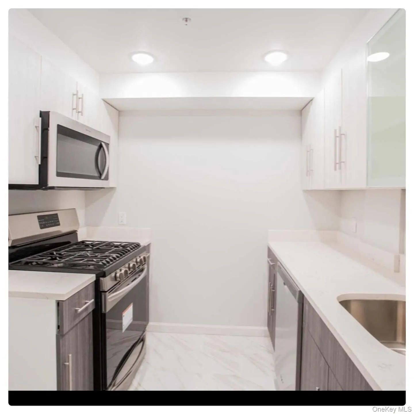 Kitchen featuring stainless steel appliances, light stone countertops, recessed lighting, modern cabinets, and glass insert cabinets Kitchen featuring stainless steel appliances, light stone countertops, recessed lighting, modern cabinets, and glass insert cabinets