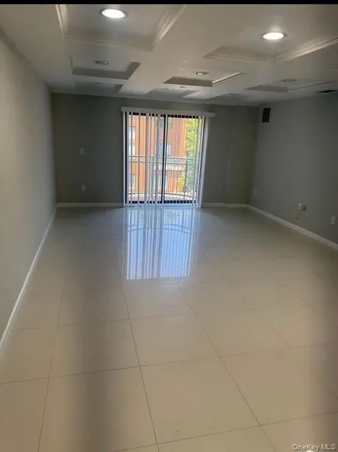 Unfurnished room with recessed lighting, coffered ceiling, beam ceiling, light tile patterned floors, and crown molding Unfurnished room with recessed lighting, coffered ceiling, beam ceiling, light tile patterned floors, and crown molding