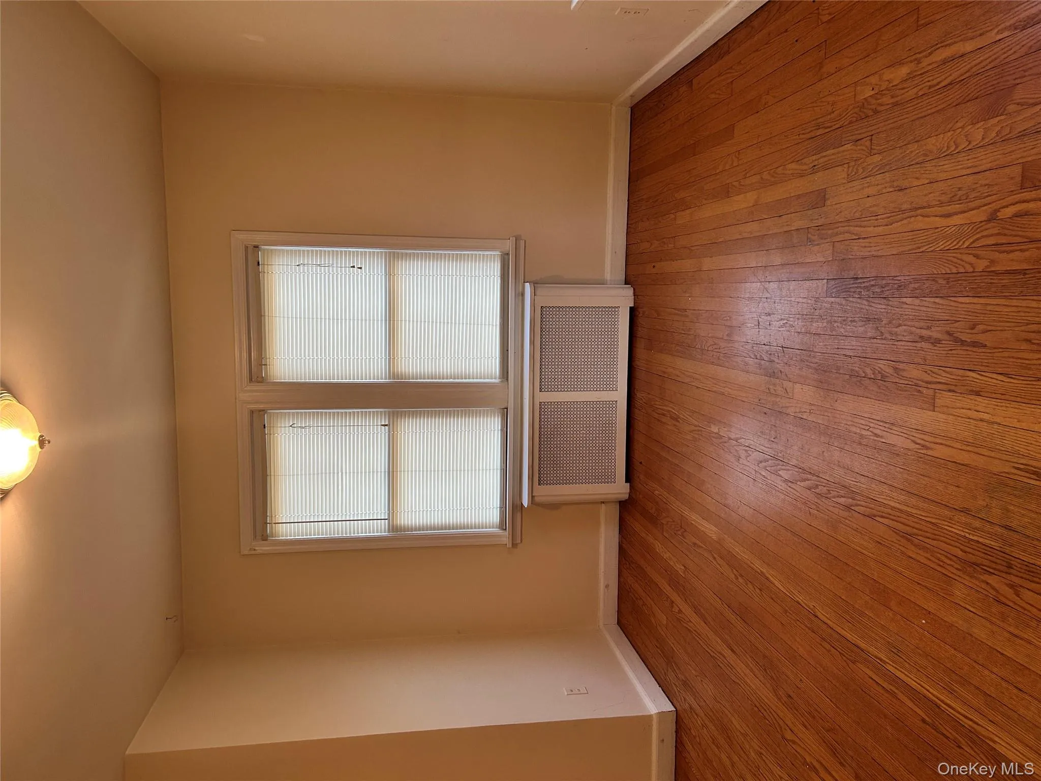 Empty room with radiator and light wood-type flooring Empty room with radiator and light wood-type flooring