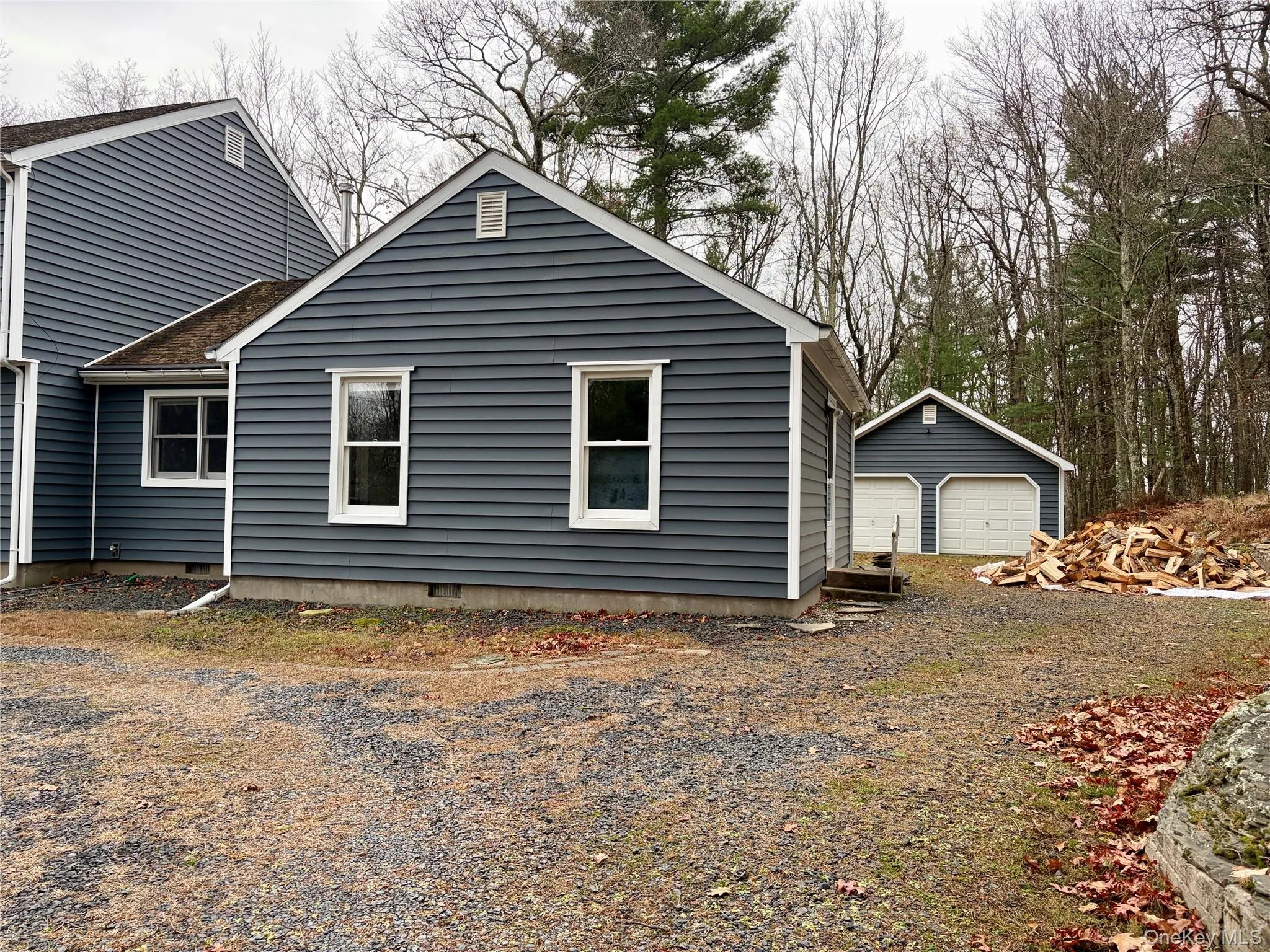 View of home's exterior featuring an outbuilding, a detached garage, and crawl space View of home's exterior featuring an outbuilding, a detached garage, and crawl space