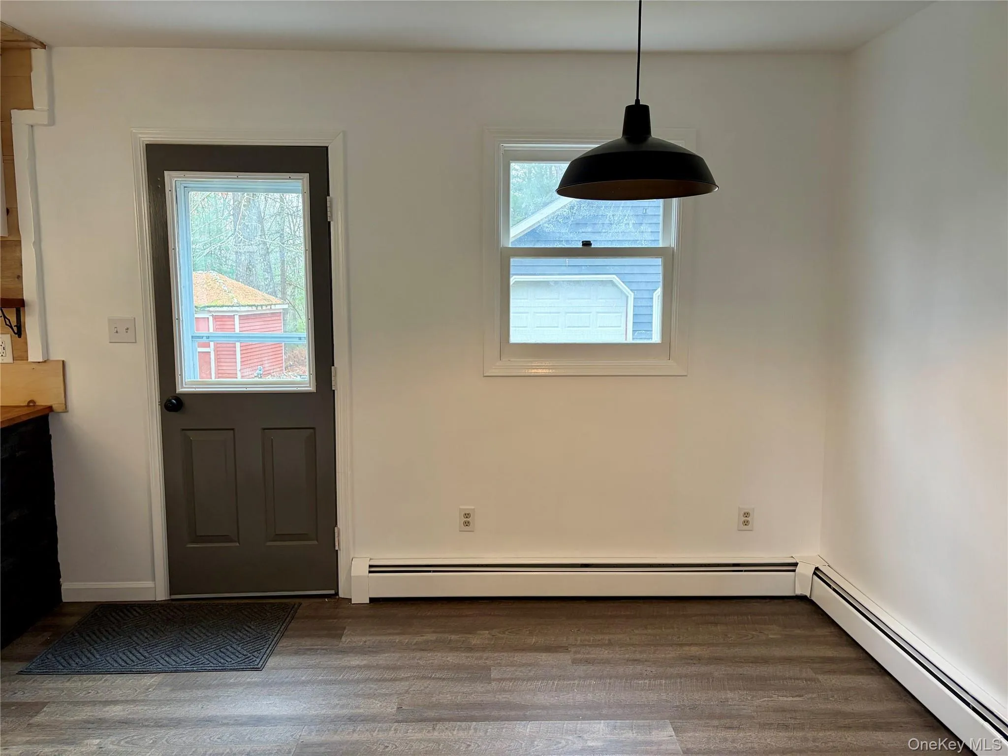 Entryway with wood finished floors and a baseboard radiator Entryway with wood finished floors and a baseboard radiator