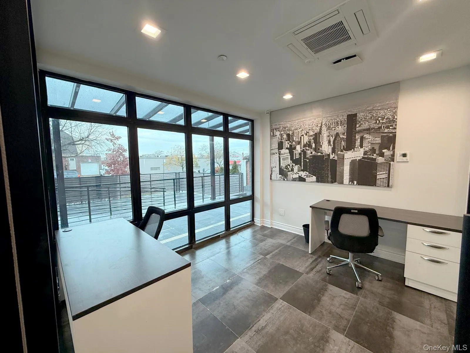 Office space featuring cooling unit, expansive windows, and recessed lighting Office space featuring cooling unit, expansive windows, and recessed lighting