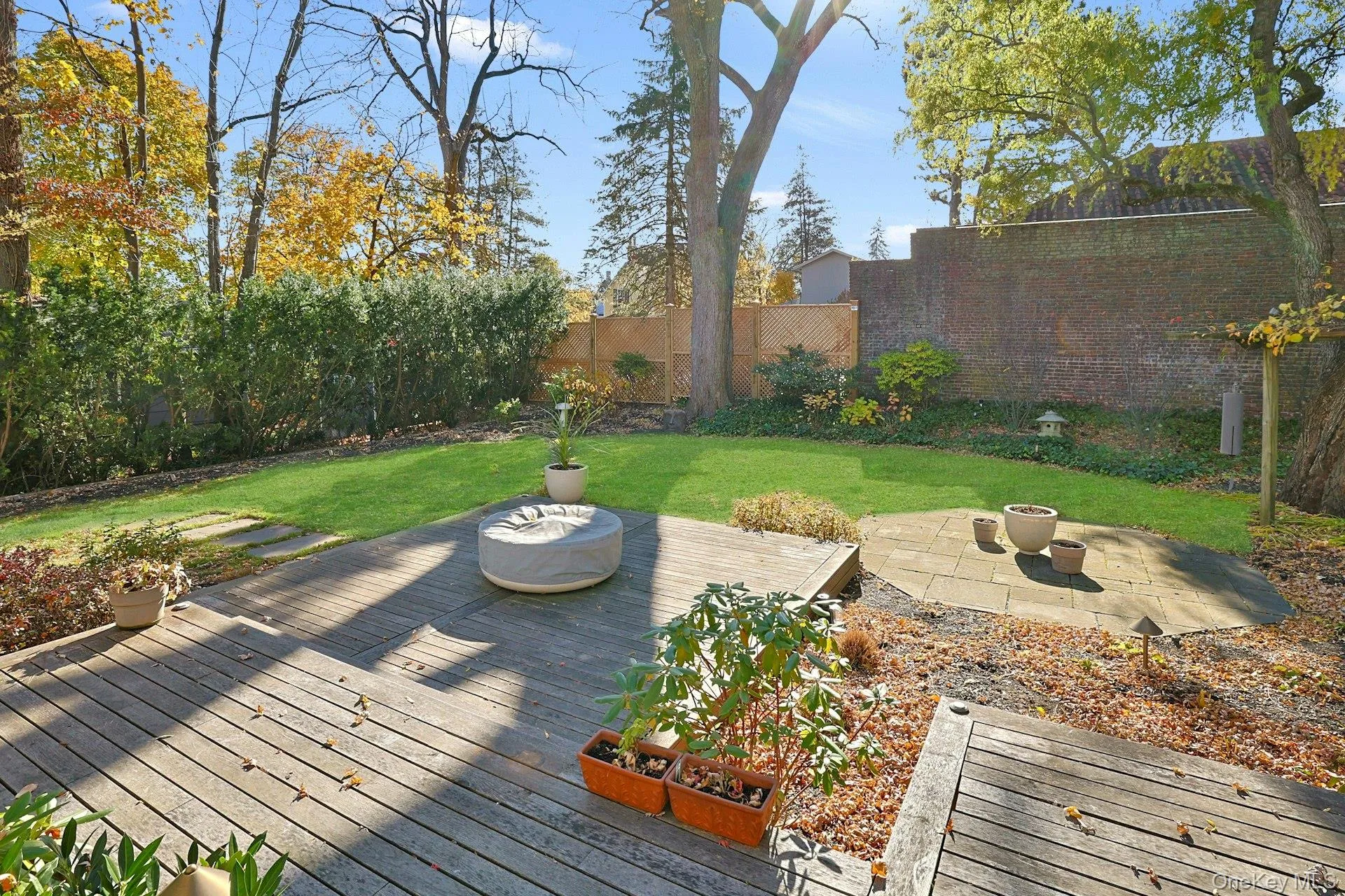 Deck featuring a fenced backyard, a fire pit, and a patio area Deck featuring a fenced backyard, a fire pit, and a patio area