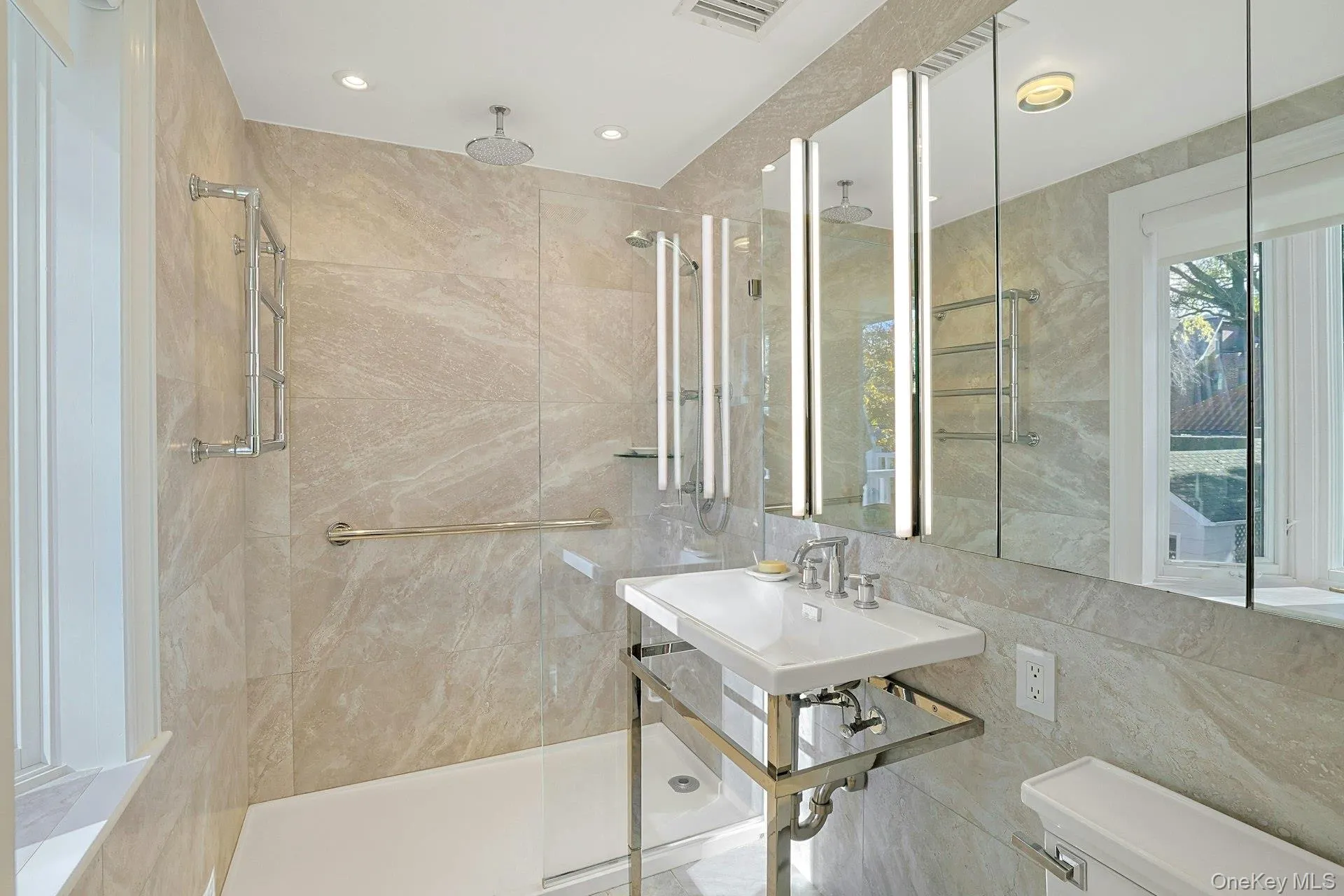 Bathroom with tile walls, a shower stall, and recessed lighting Bathroom with tile walls, a shower stall, and recessed lighting