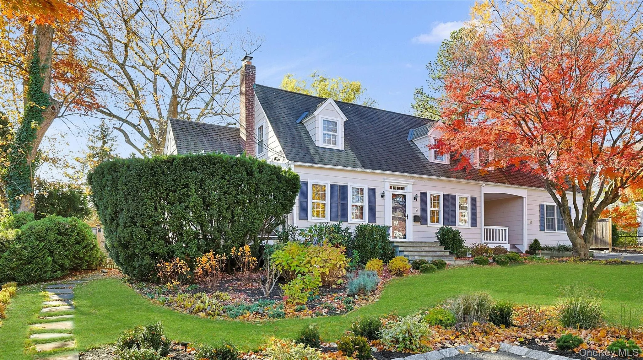 Cape cod house featuring a front yard, a chimney, and roof with shingles Cape cod house featuring a front yard, a chimney, and roof with shingles