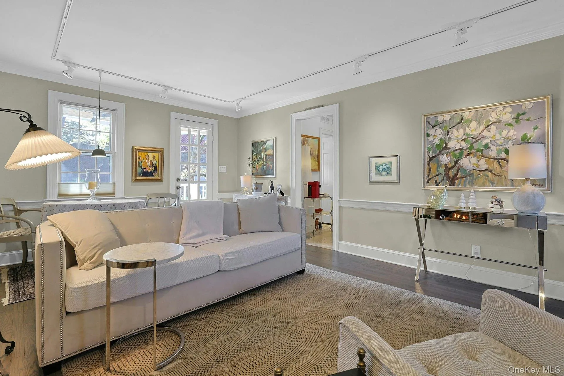 Living area with track lighting and wood finished floors Living area with track lighting and wood finished floors