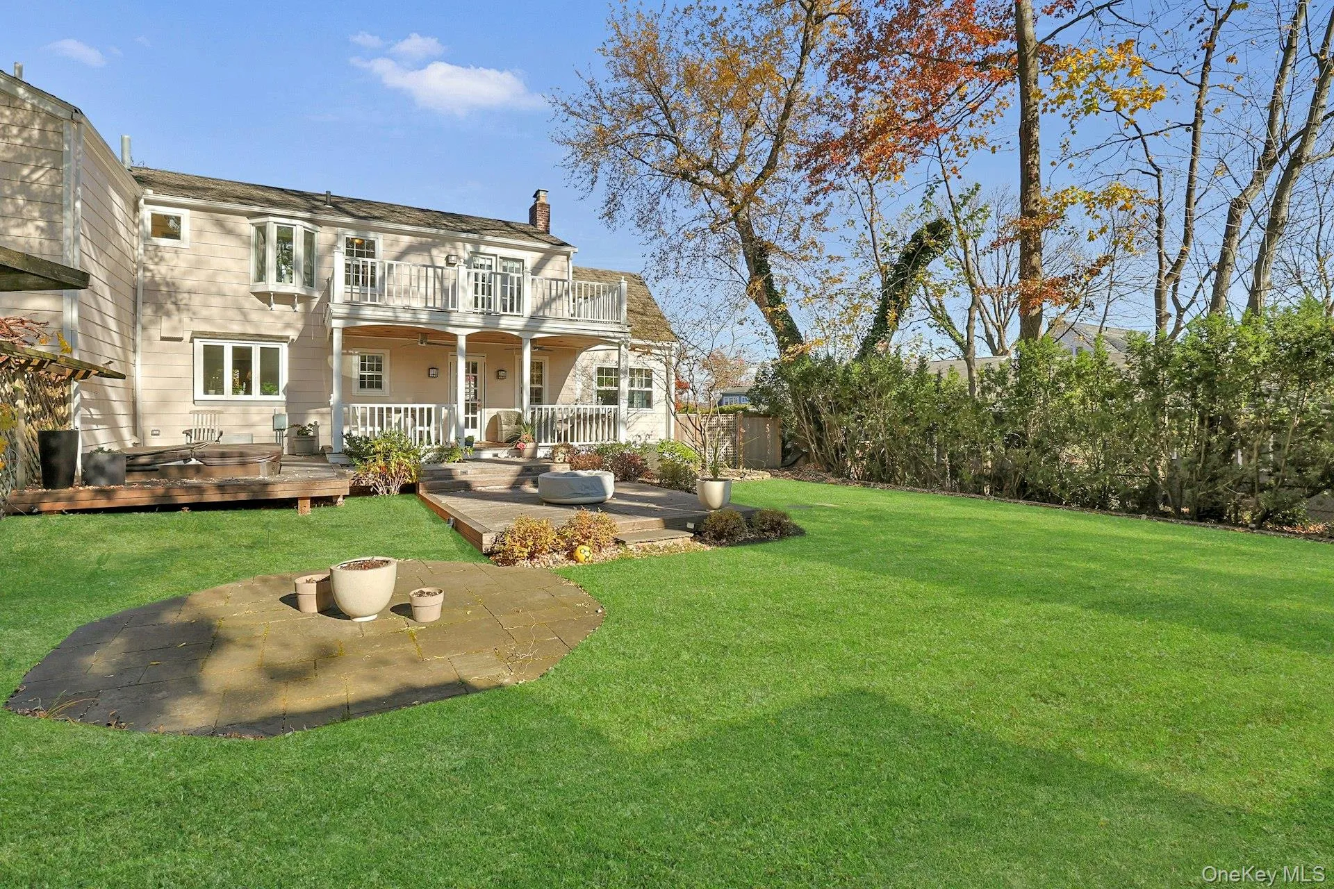 Rear view of house featuring a patio area and a chimney Rear view of house featuring a patio area and a chimney
