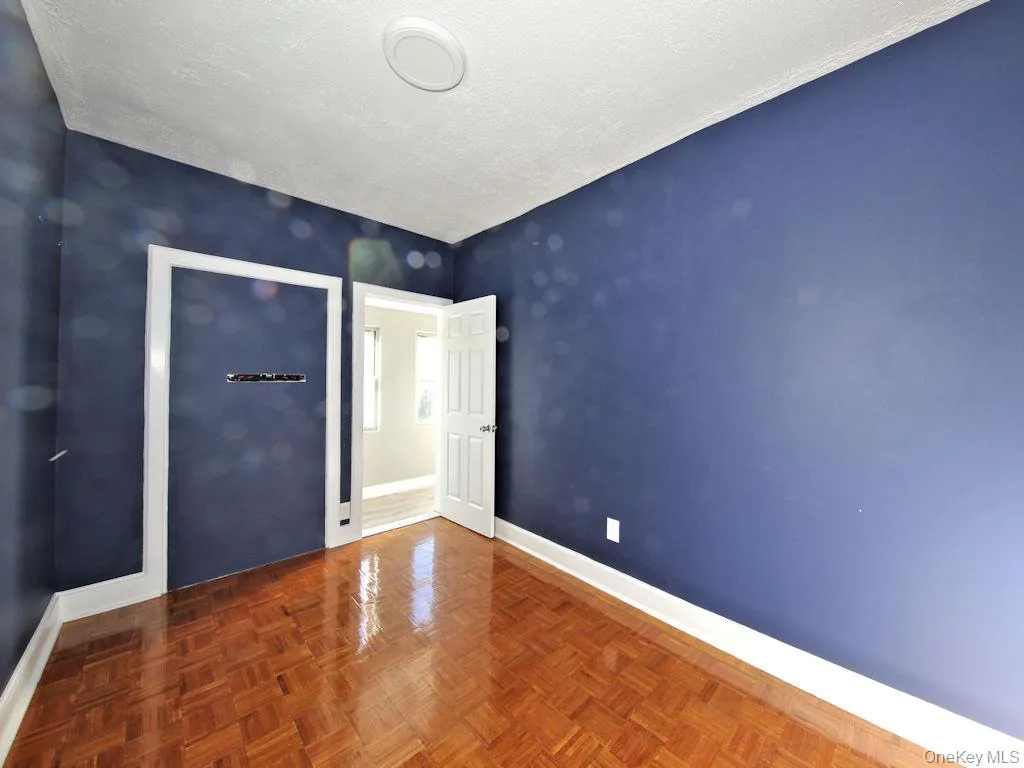 Unfurnished bedroom with baseboards and a textured ceiling Unfurnished bedroom with baseboards and a textured ceiling