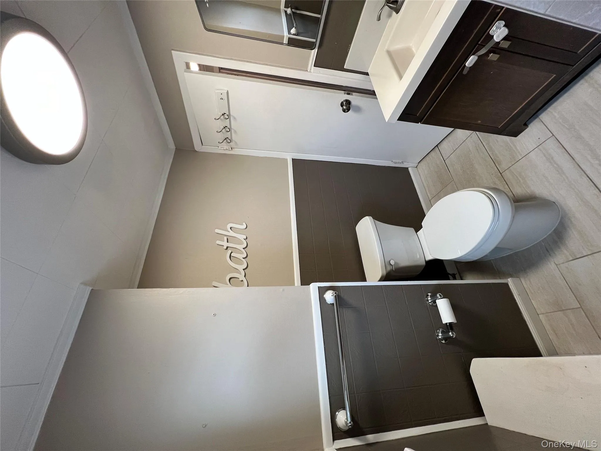 Bathroom with vanity, crown molding, and a wainscoted wall Bathroom with vanity, crown molding, and a wainscoted wall